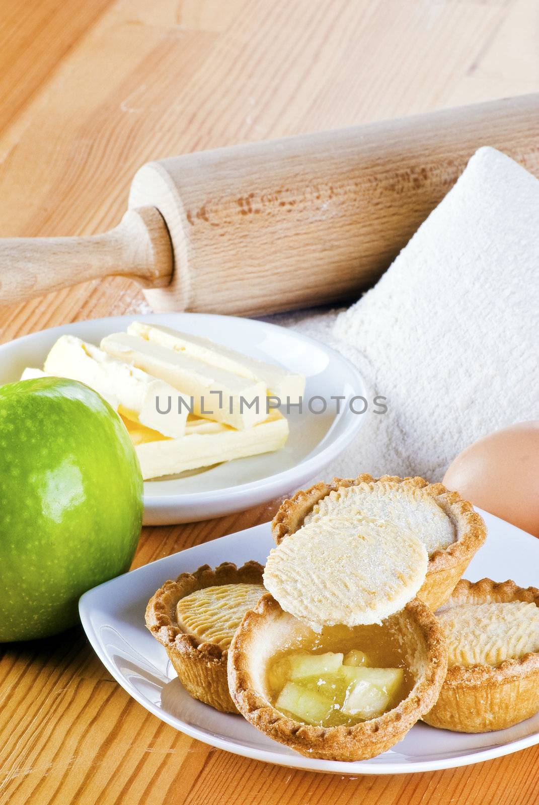 Freshly made apple pies on the table with one open