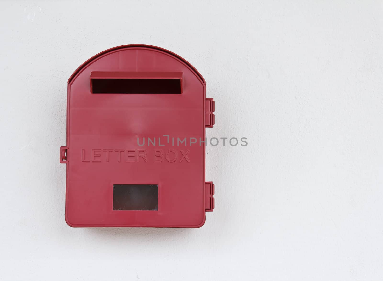 Red mailbox on white wall background at Malaysia