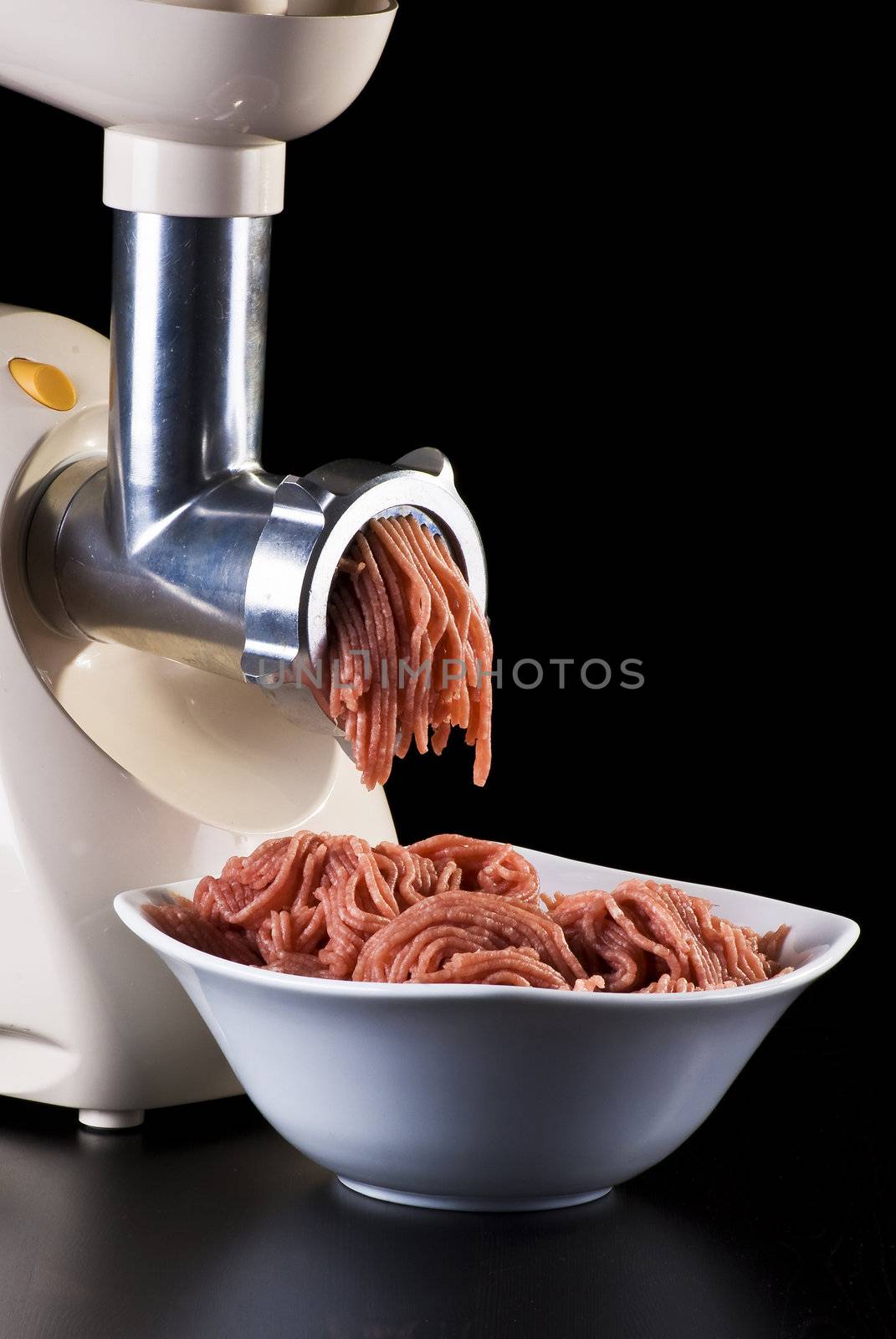 Bowl of mince with electric meat grinder