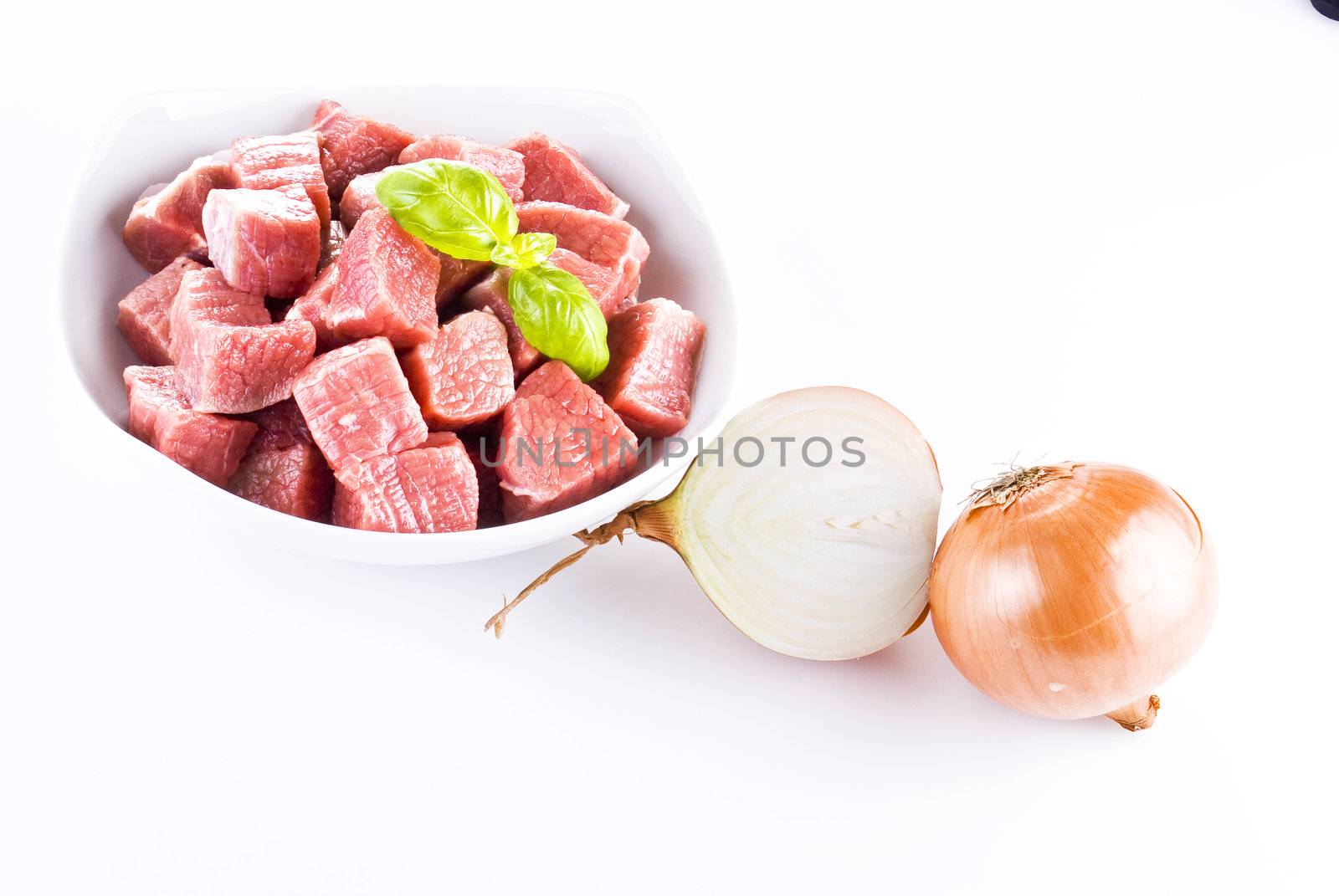 Diced beef with onion over white background