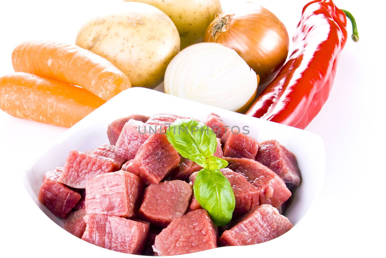 Diced beef with vegetables over white background