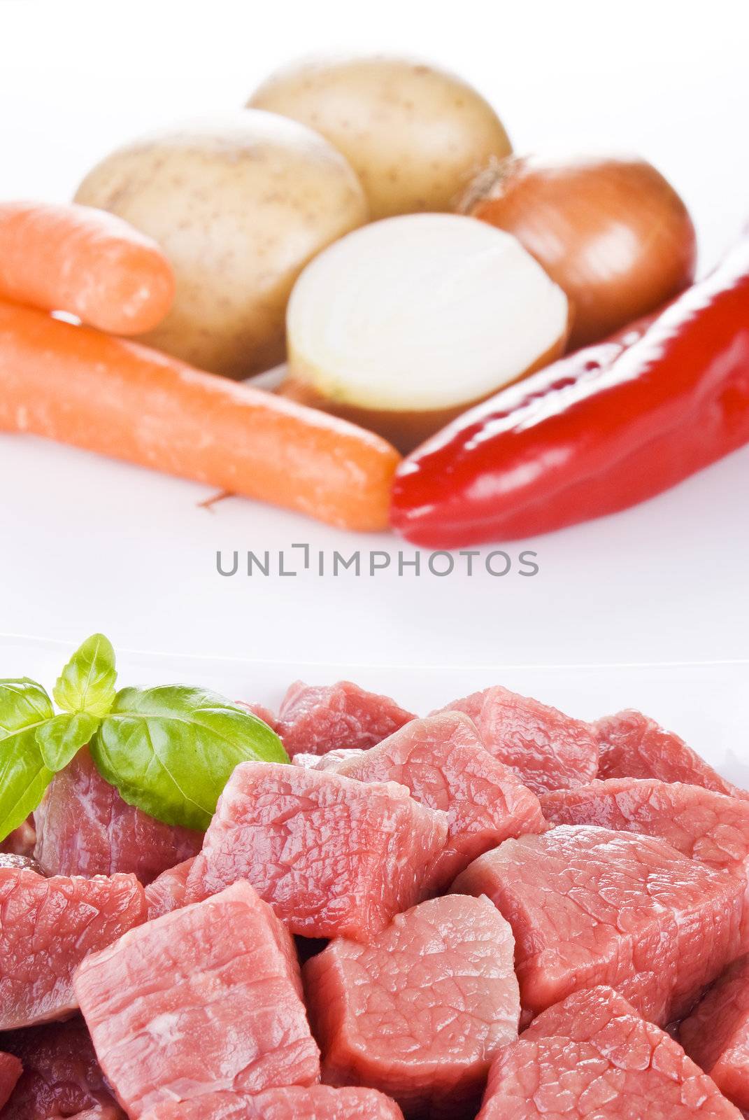 Close up of diced beef with vegetables over white background