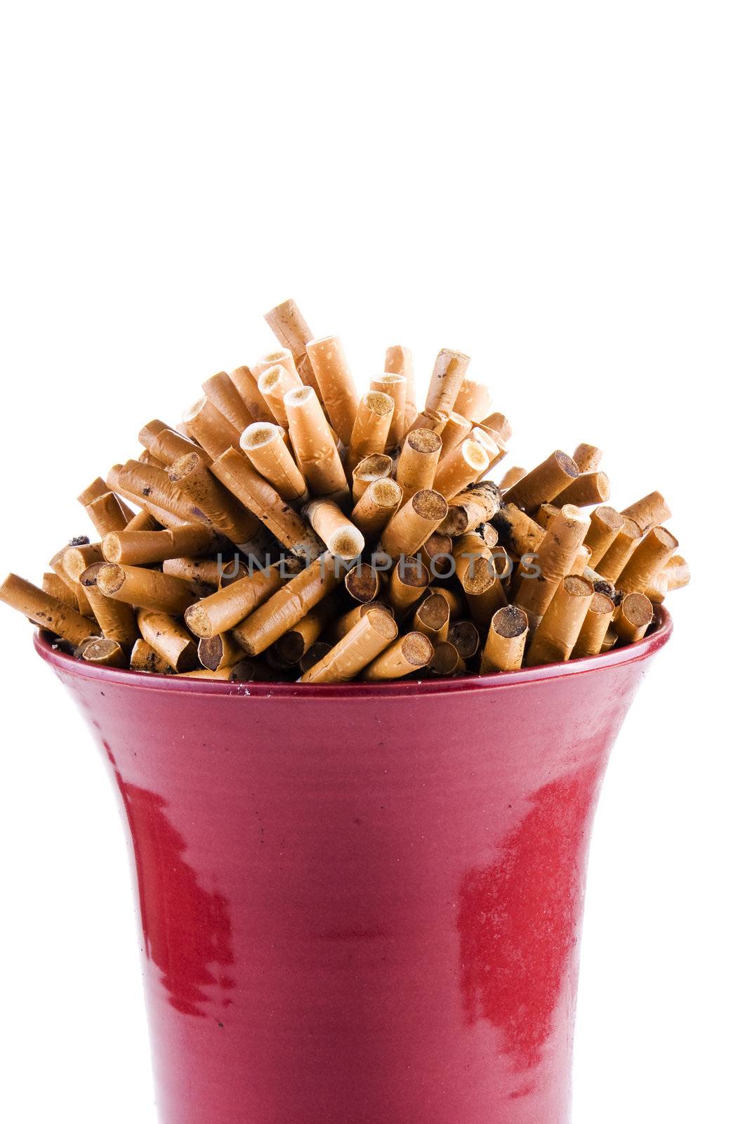 Full bowl of cigarettes end over white background