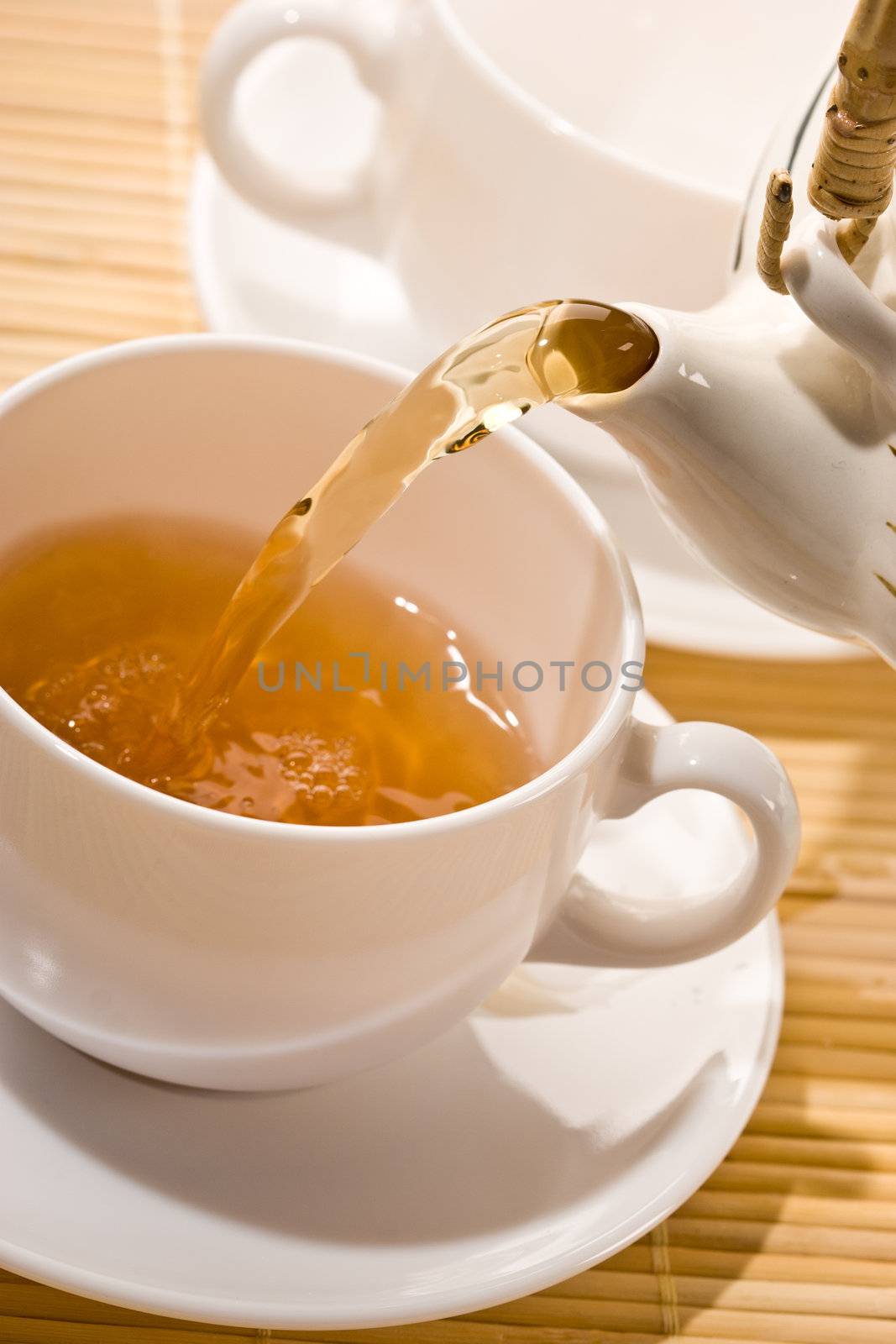 food series: flowing golden tea into cup