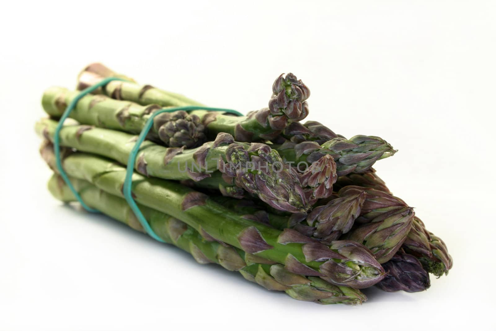 a bundle of green asparagus on a white background