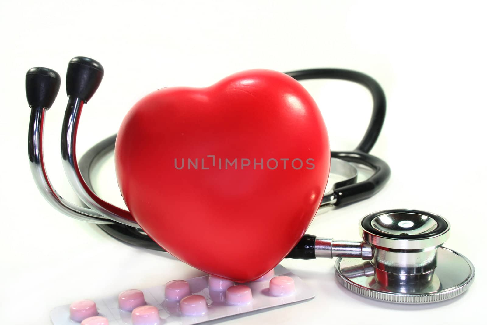 Stethoscope with heart on white background