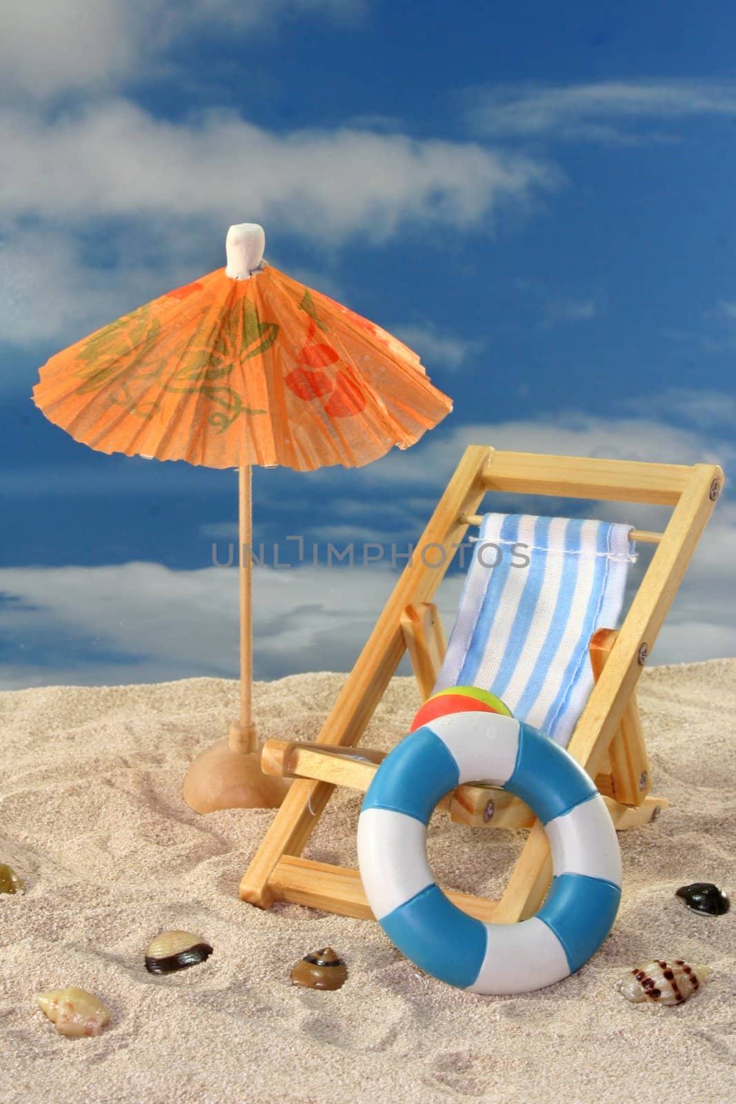 Deck chair and sun umbrella on a sandy beach