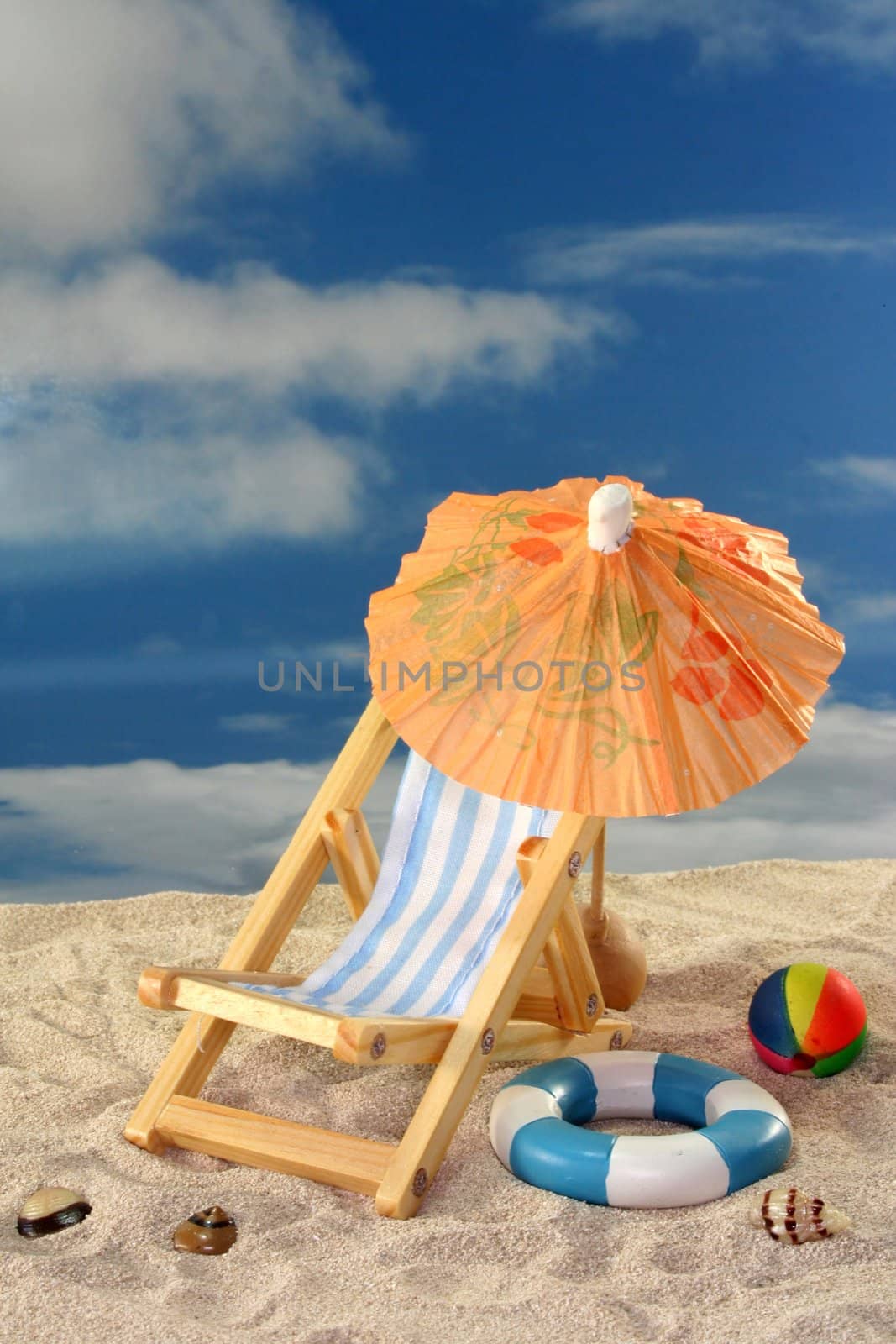 Deck chair and sun umbrella on a sandy beach
