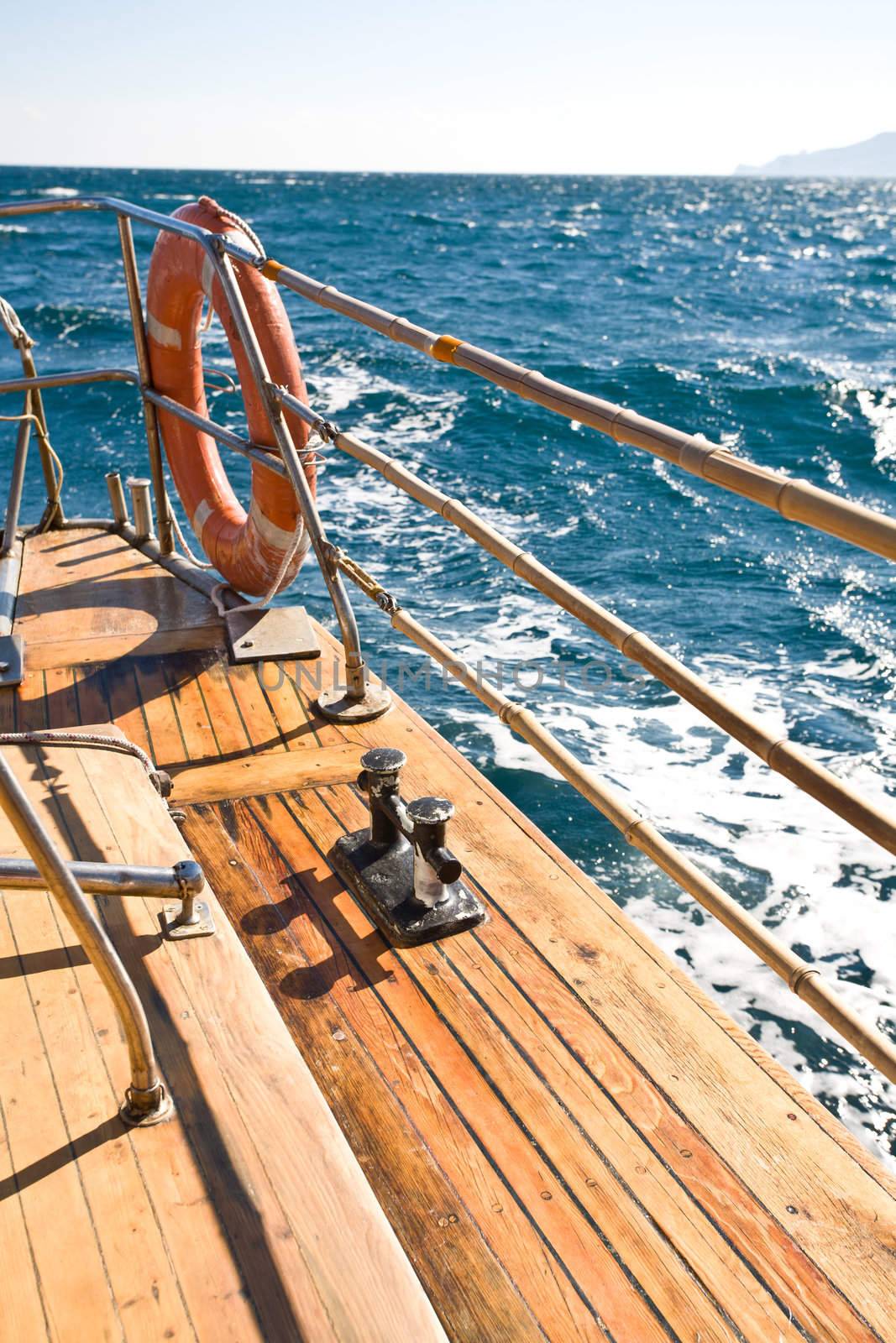 summer series: modern wooden yacht in the sea. Deck view