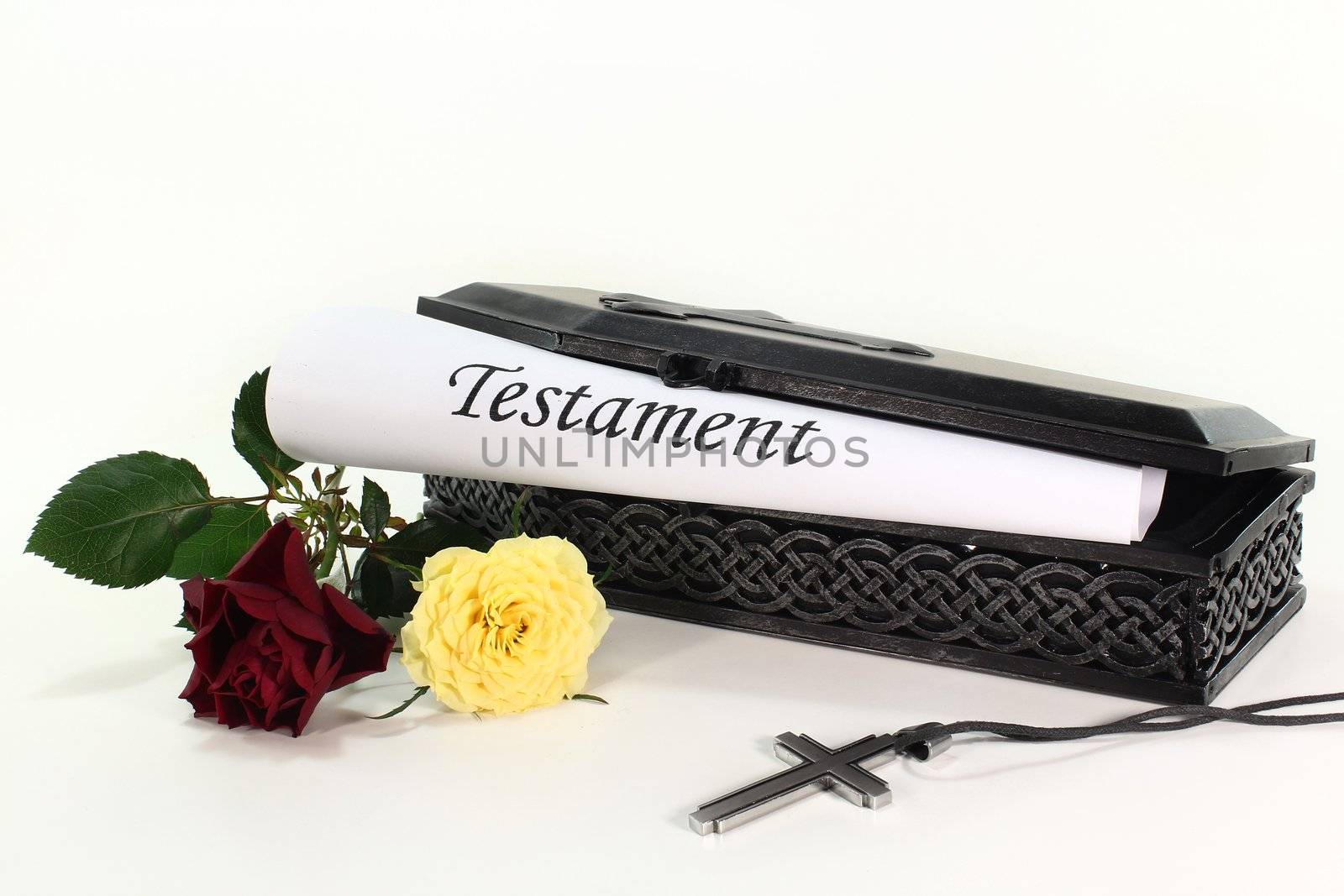 a small coffin with roses and Testament