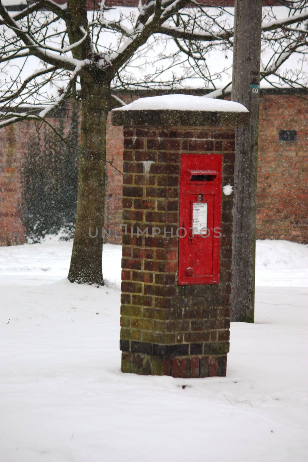A snow covered Post box