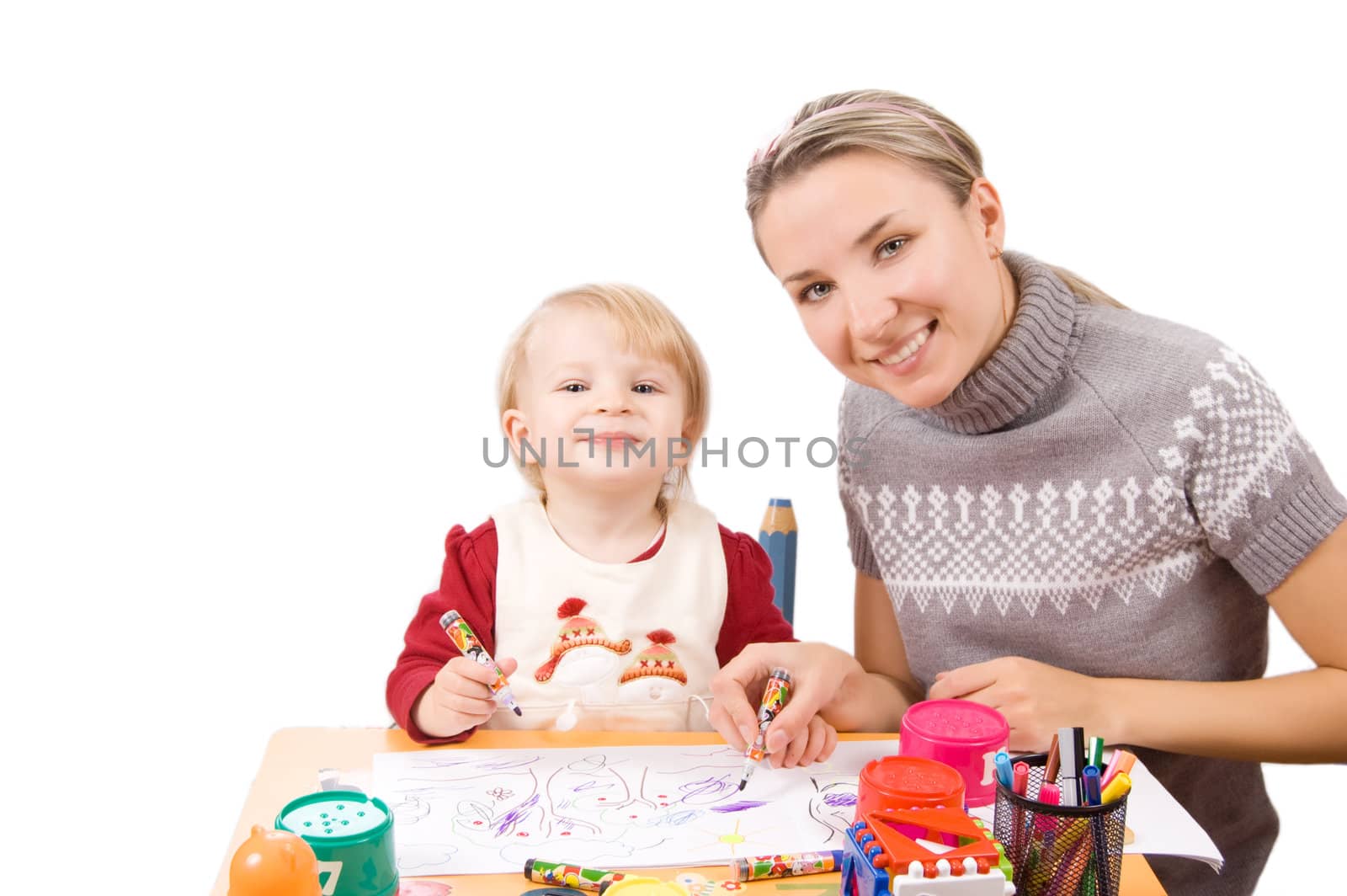 Smiling girl drawing with her mother over white