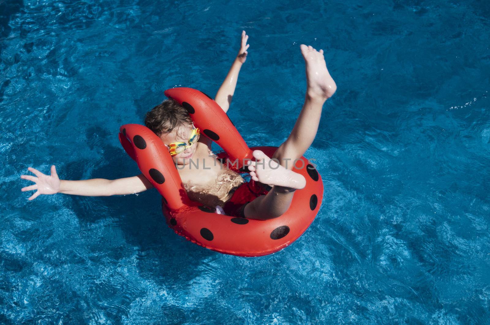 Young boy with attitude showing floating in a pool