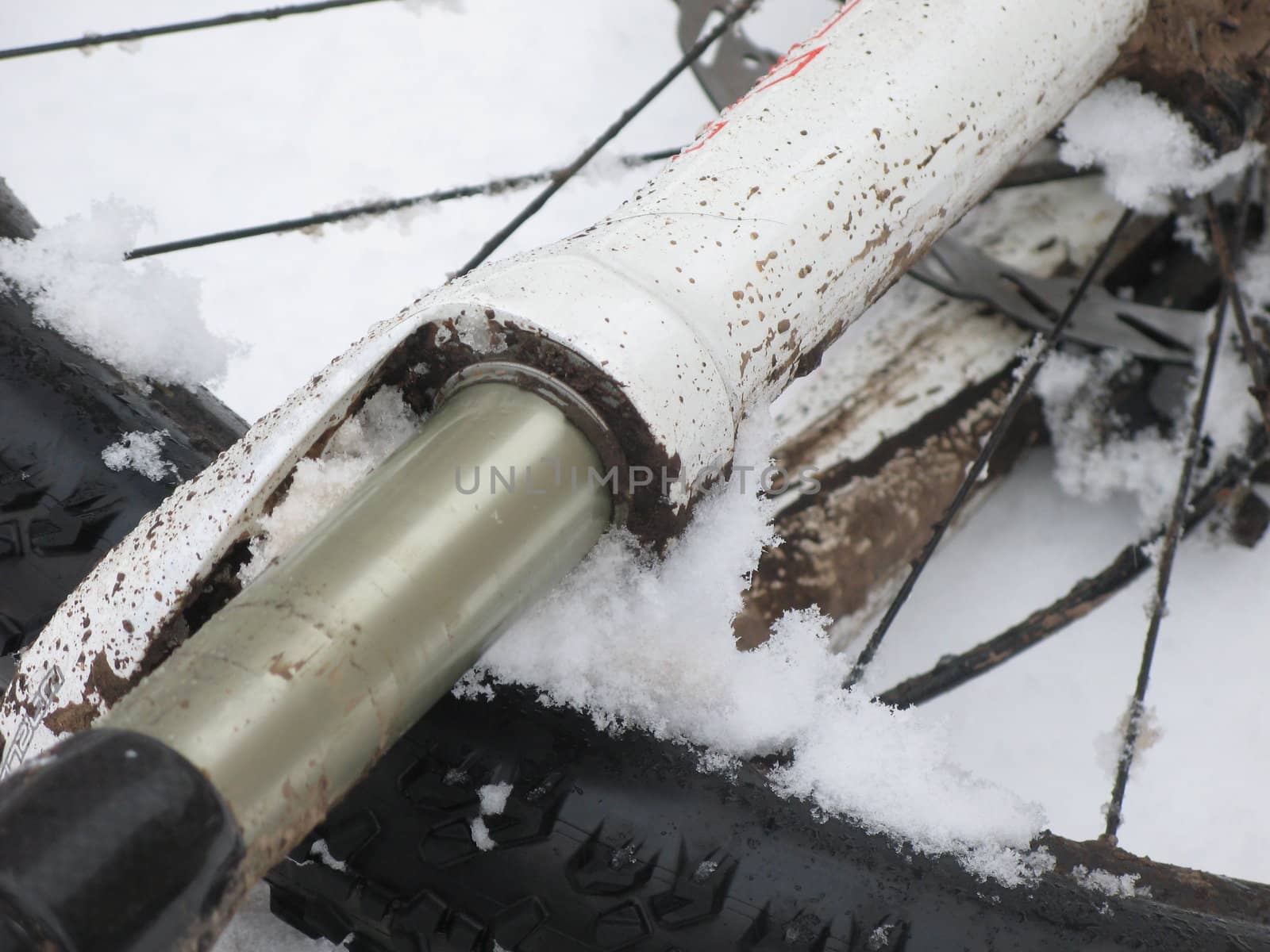 Mountain bike forks covered in mud and snow