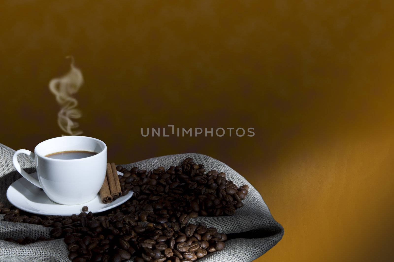 cup of coffee and coffee beans on the Sacking, abstract grunge background