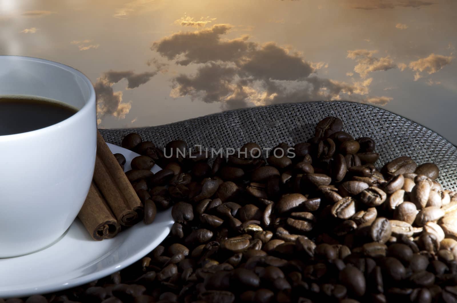 cup of coffee and coffee beans on the Sacking, evening sky background
