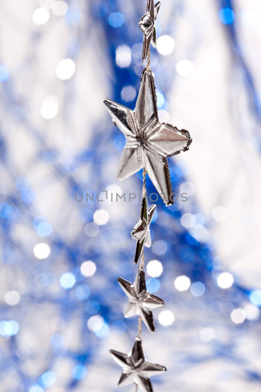 Holiday series: christmas silver stars on the shiny garland background