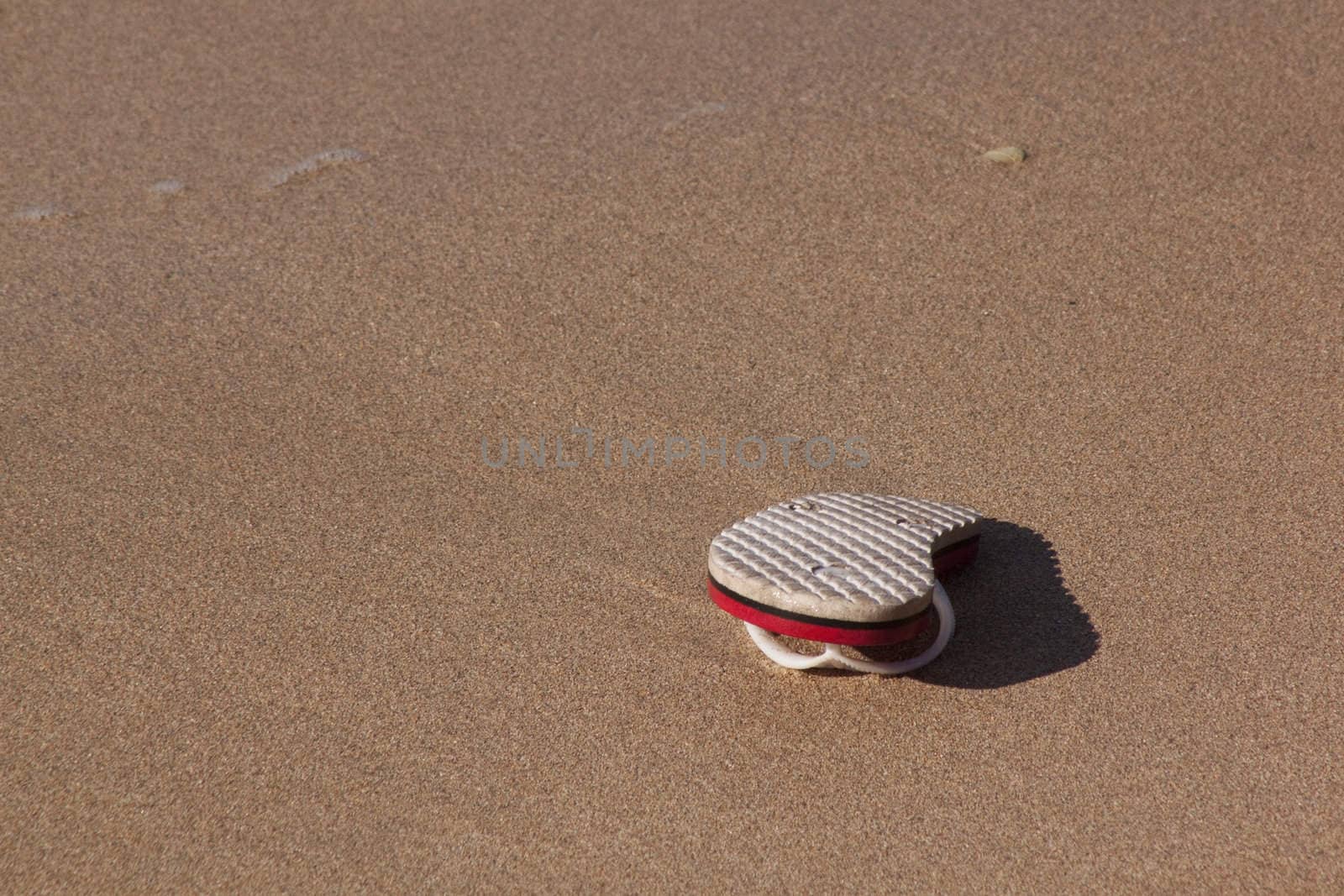 abandoned flip flop on the beach