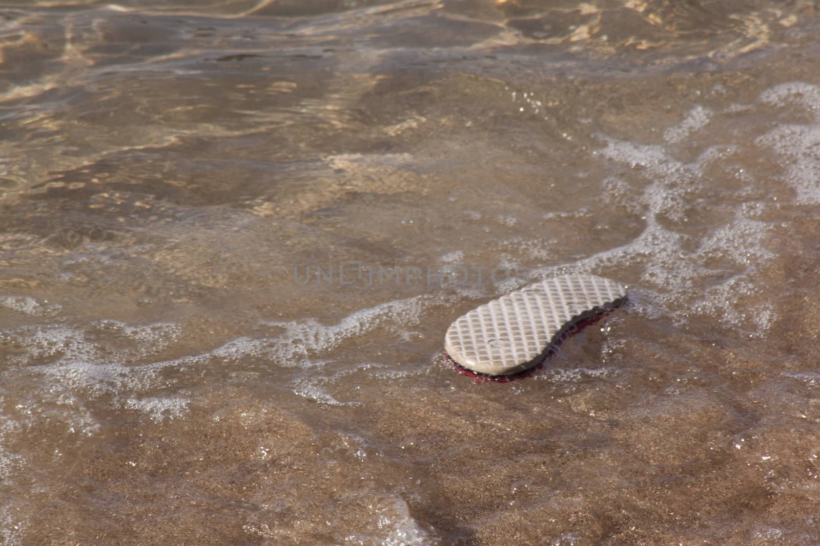abandoned flip flop on the beach by jeremywhat