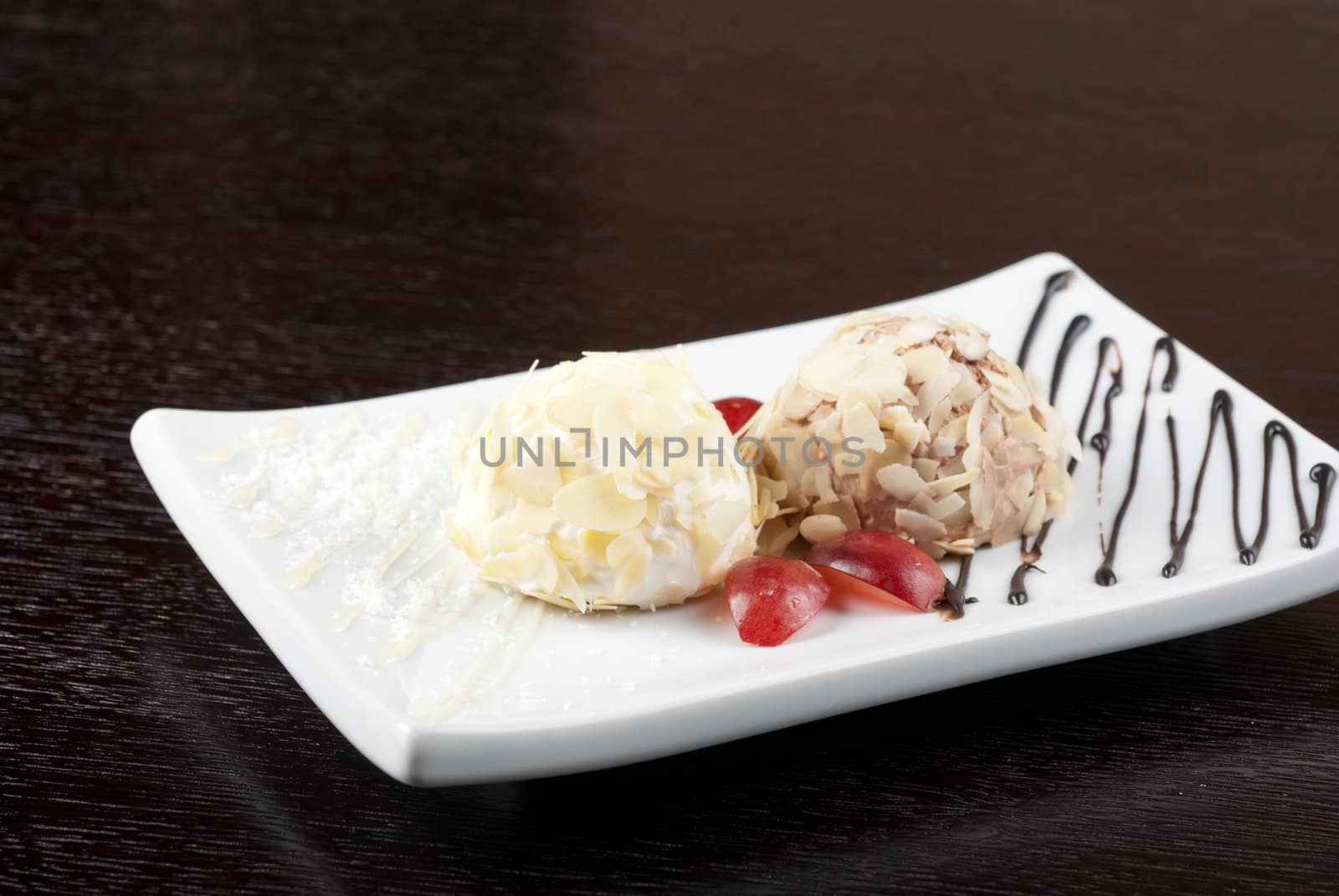 Dessert set of ice-cream with almond, chocolate and grapes