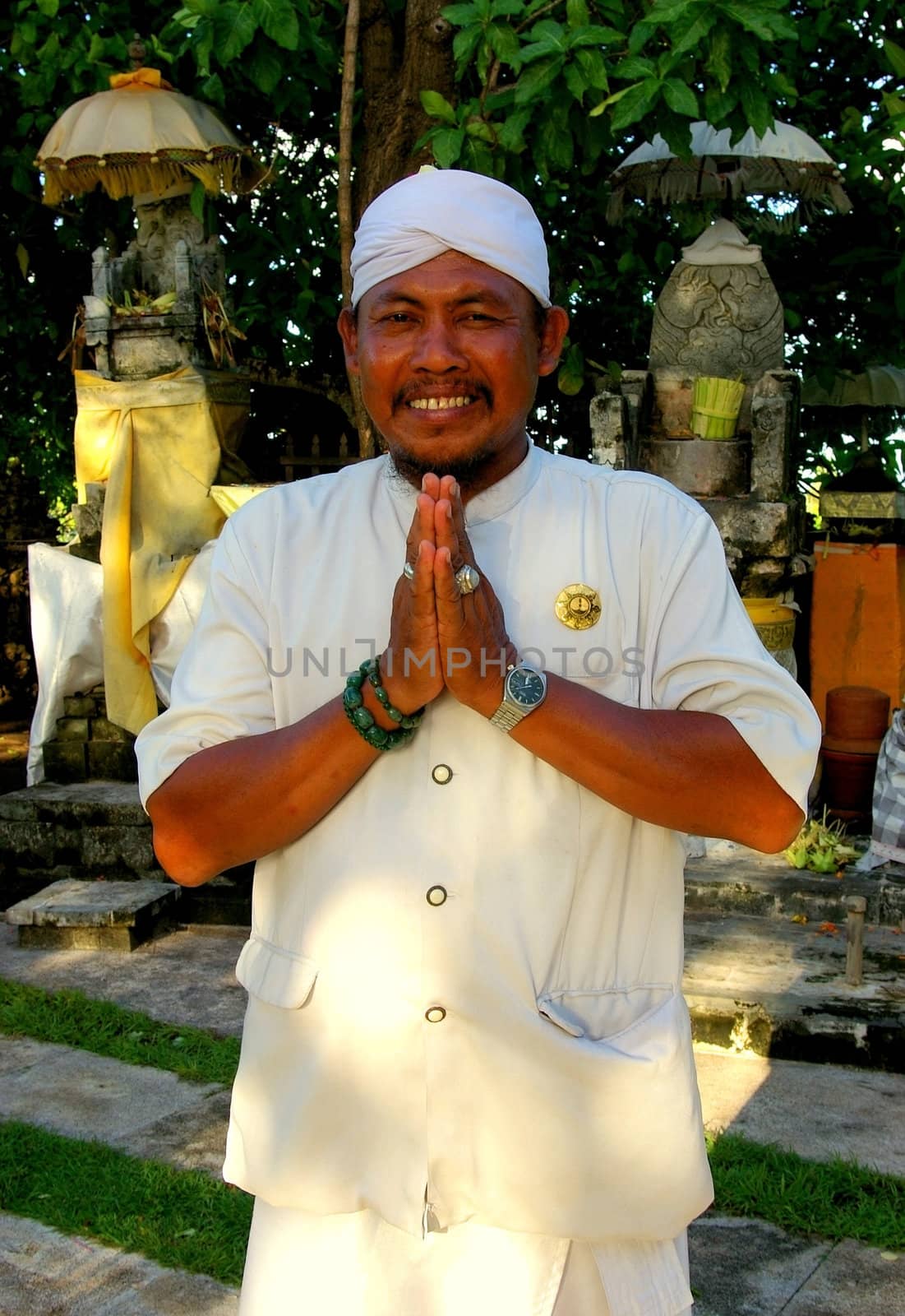 A Balinese man wearing traditional attire, at a temple in Nusa Dua, Bali, Indonesia.