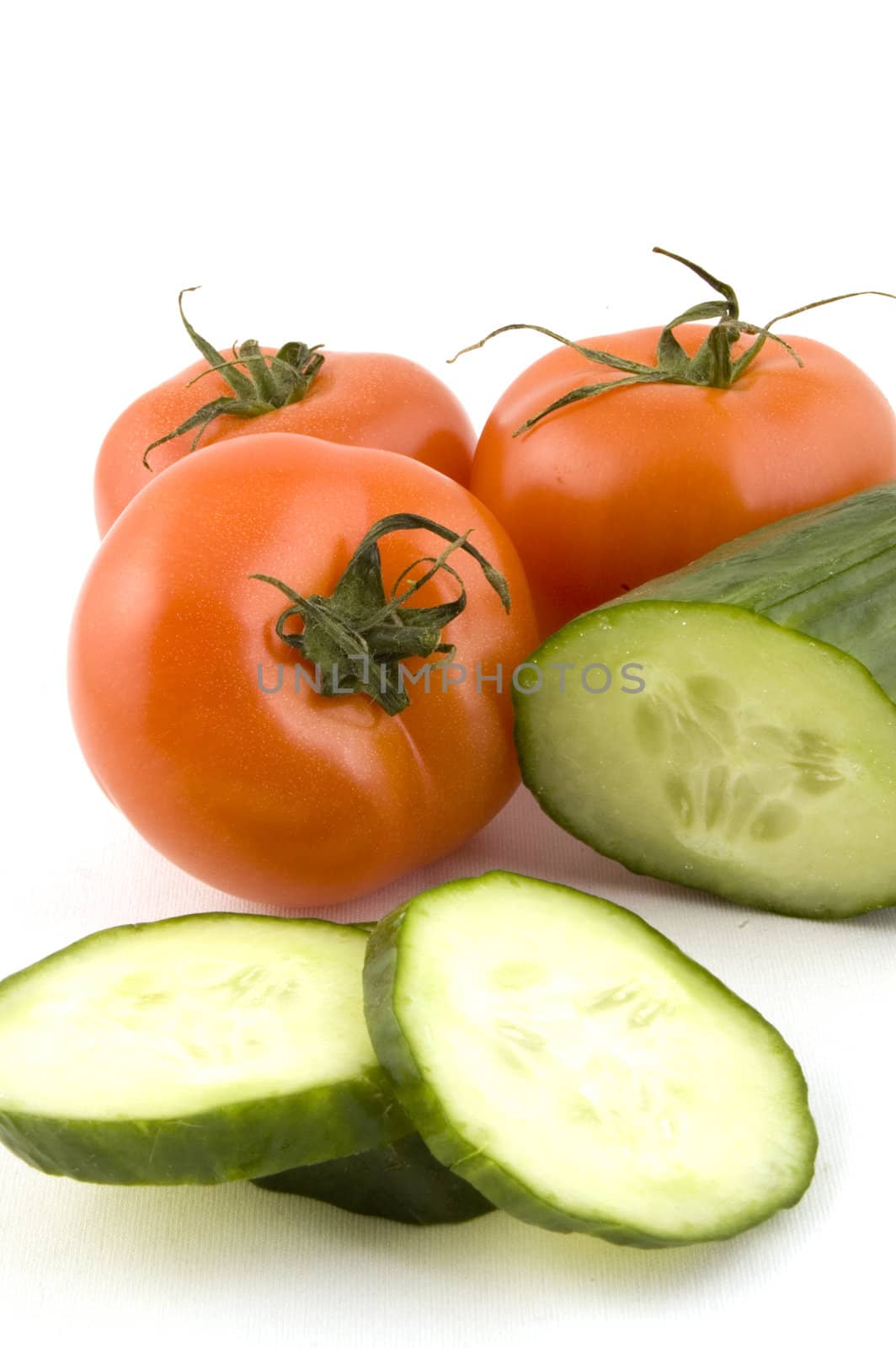 fresh tomatoes and a cucumber with slices