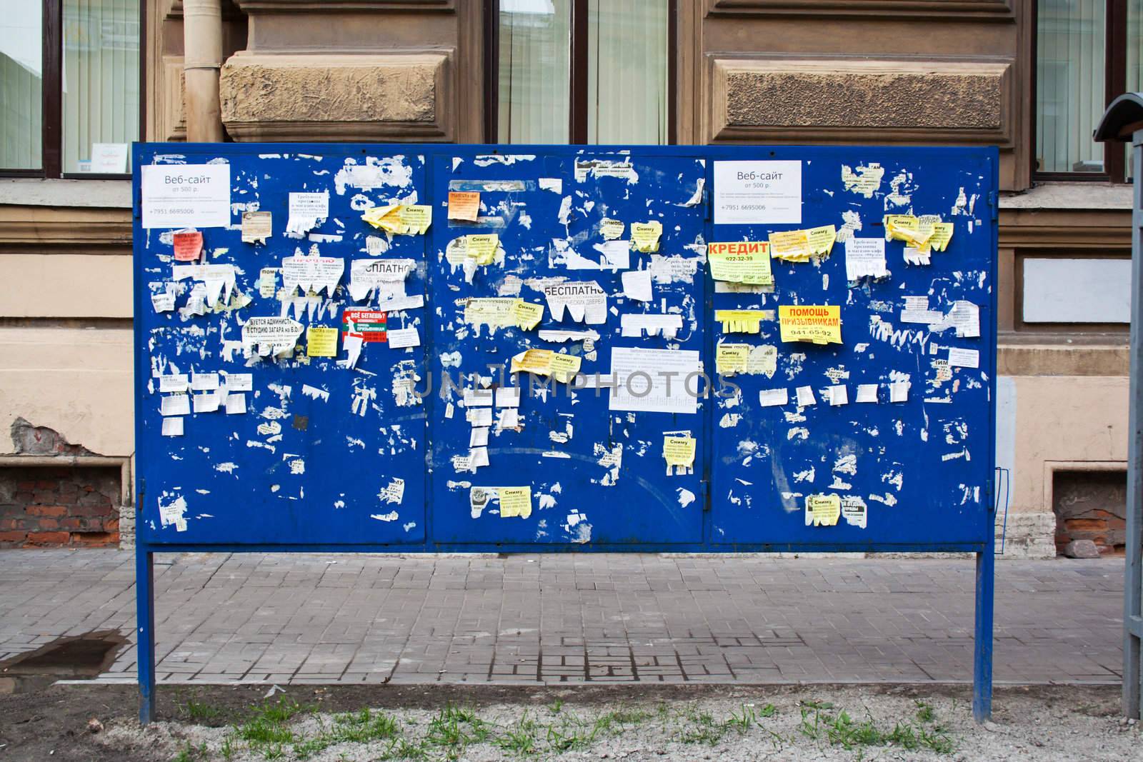 street billboard with paper advertising and announcement