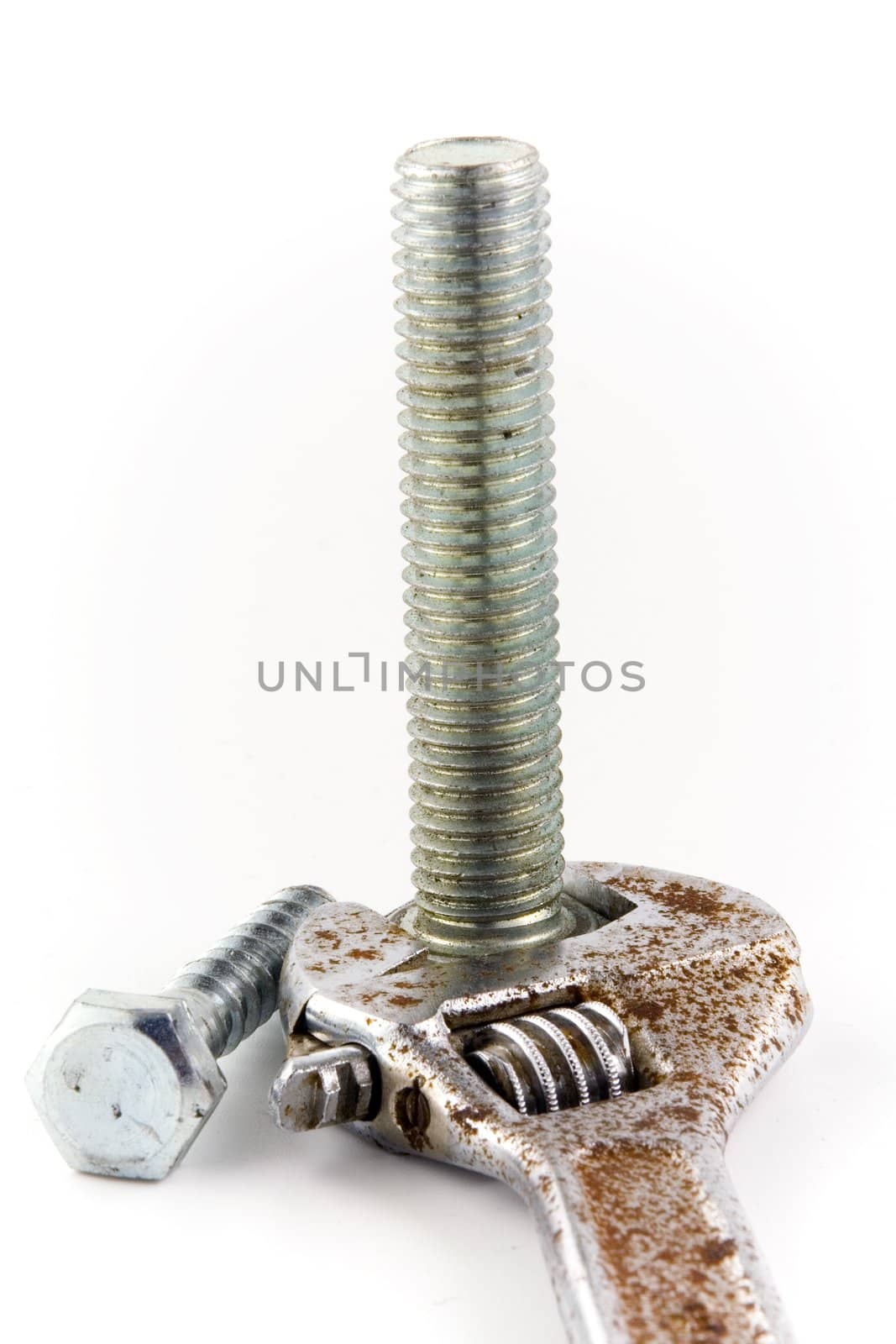 Screw and rusty wrench on white background. Isolated object