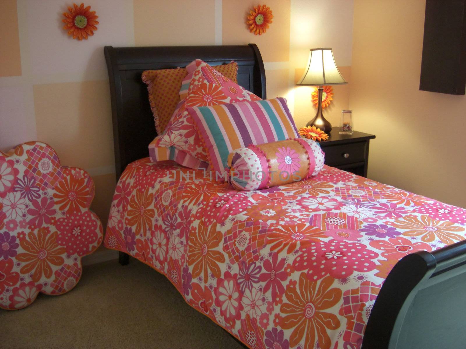 A bedroom is designed in a color coordination of pink.
