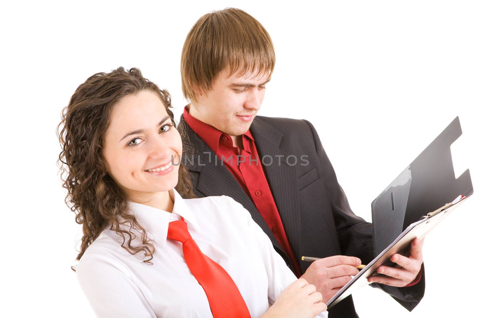 smiling man and woman dressed for office stand with a carpet