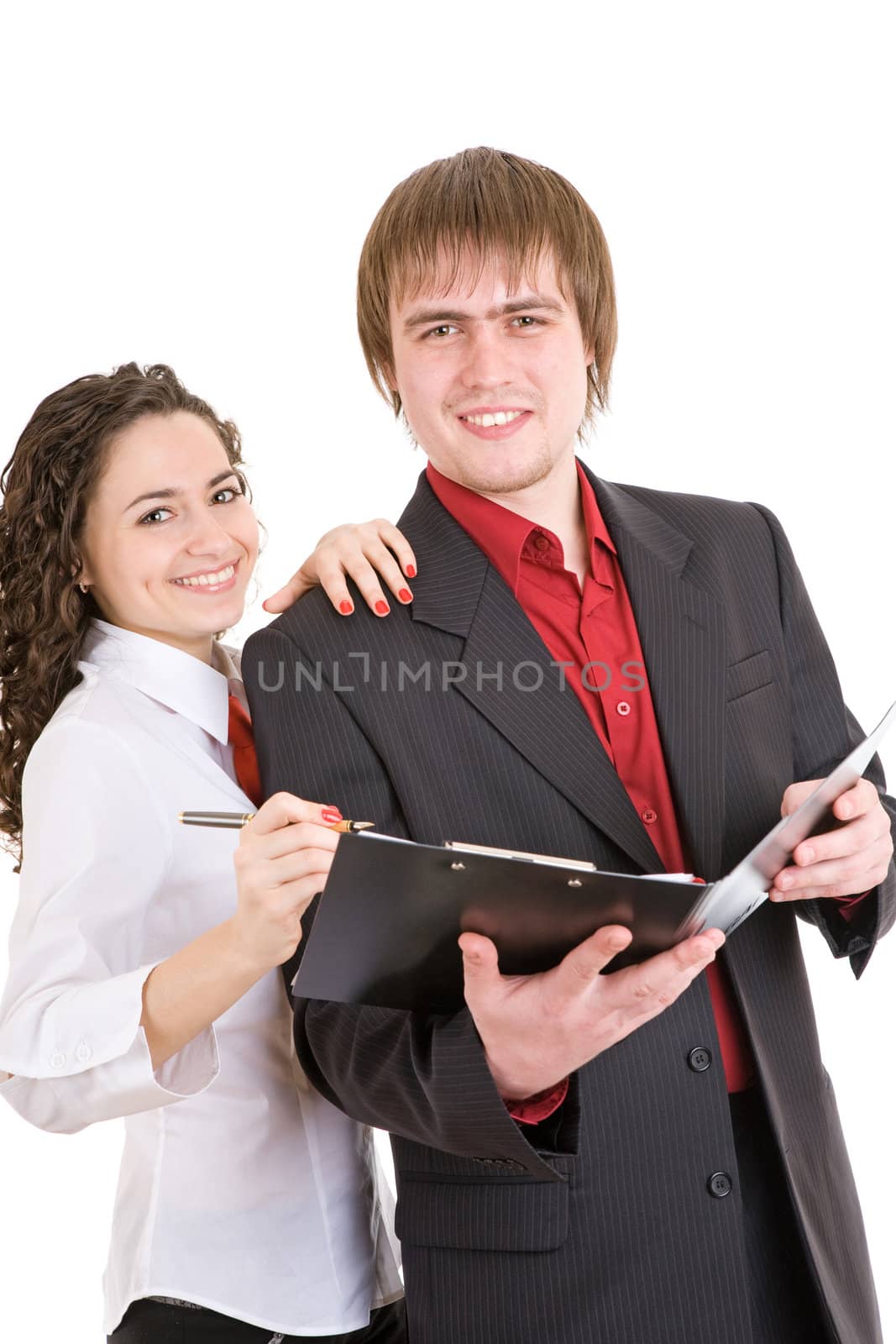 smiling man and woman dressed for office stand with a carpet