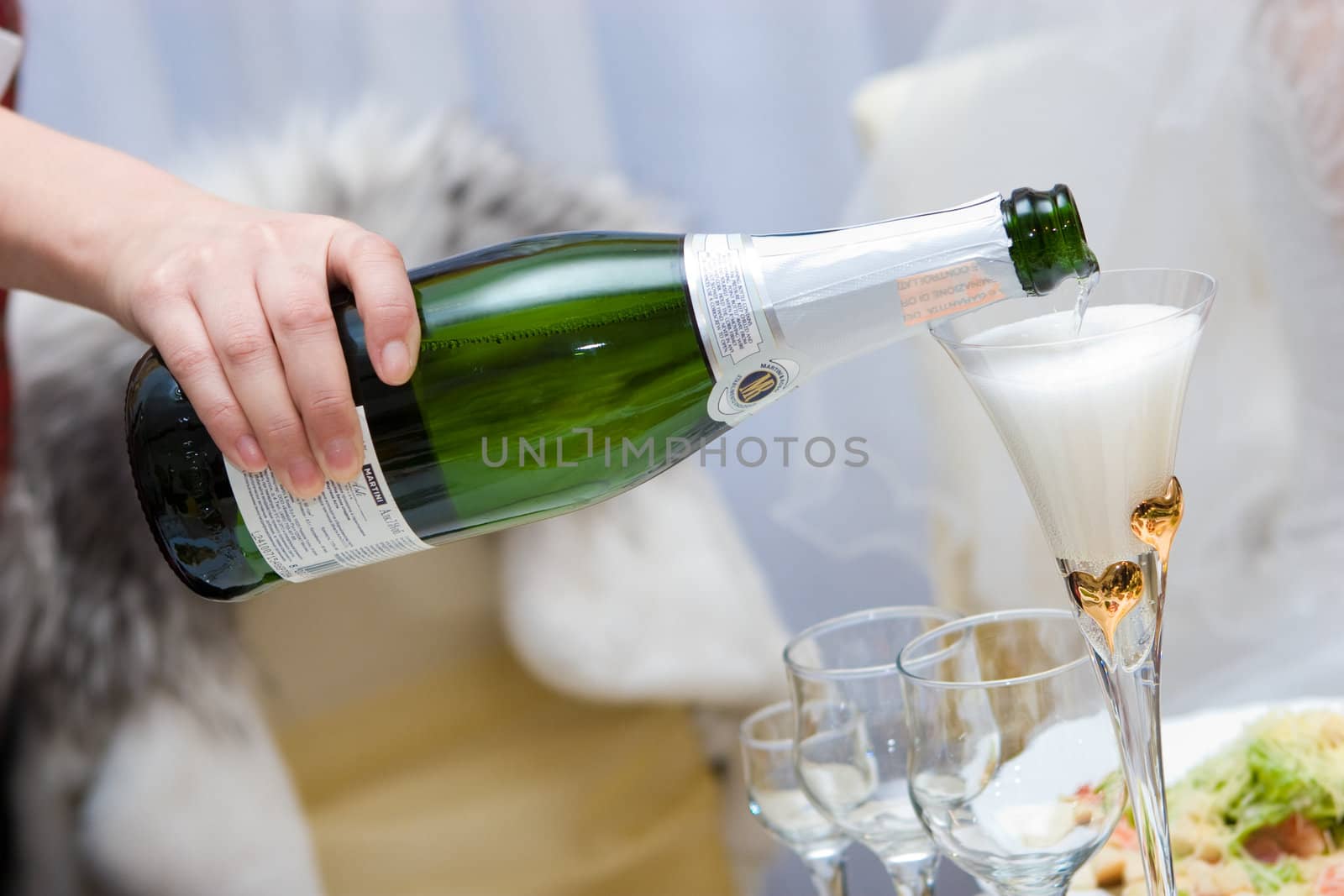 pouring of champagne to the glasses