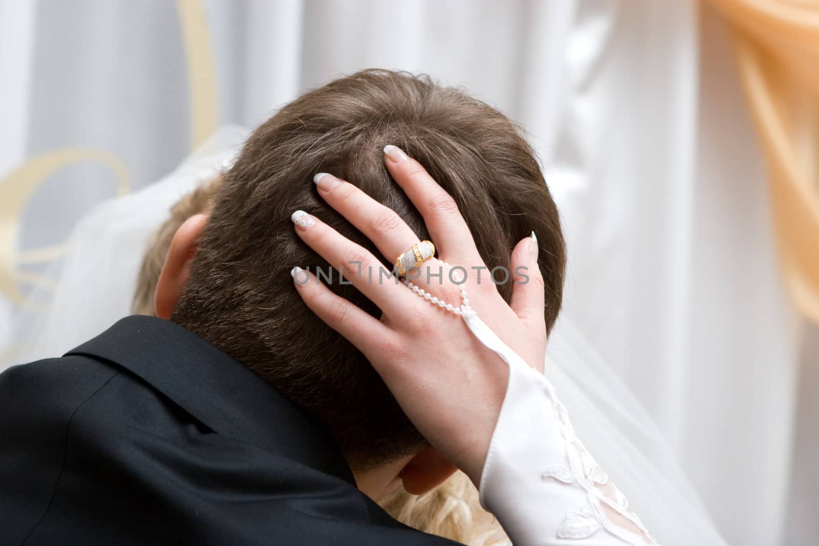 woman kisses the man and embrases his head with her hand