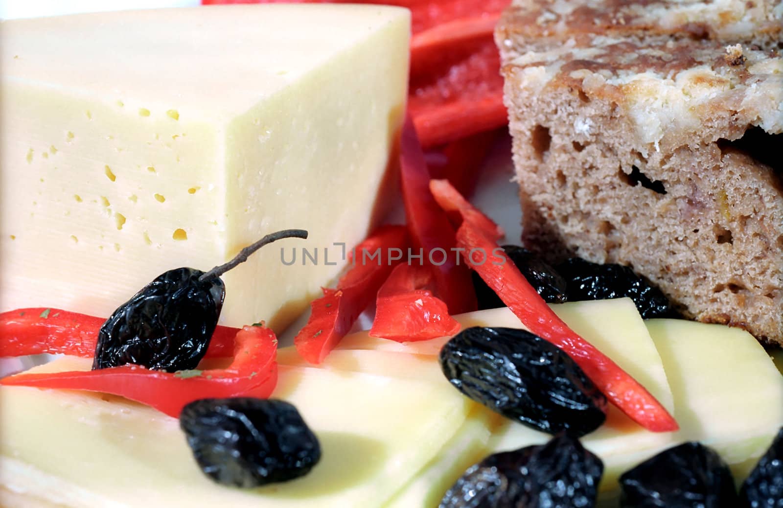 Cheese, olives, farm bread and  paprica close up