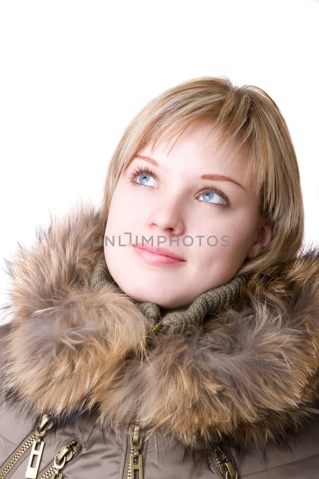 thoughtful girl in a jacket with a collar of fur