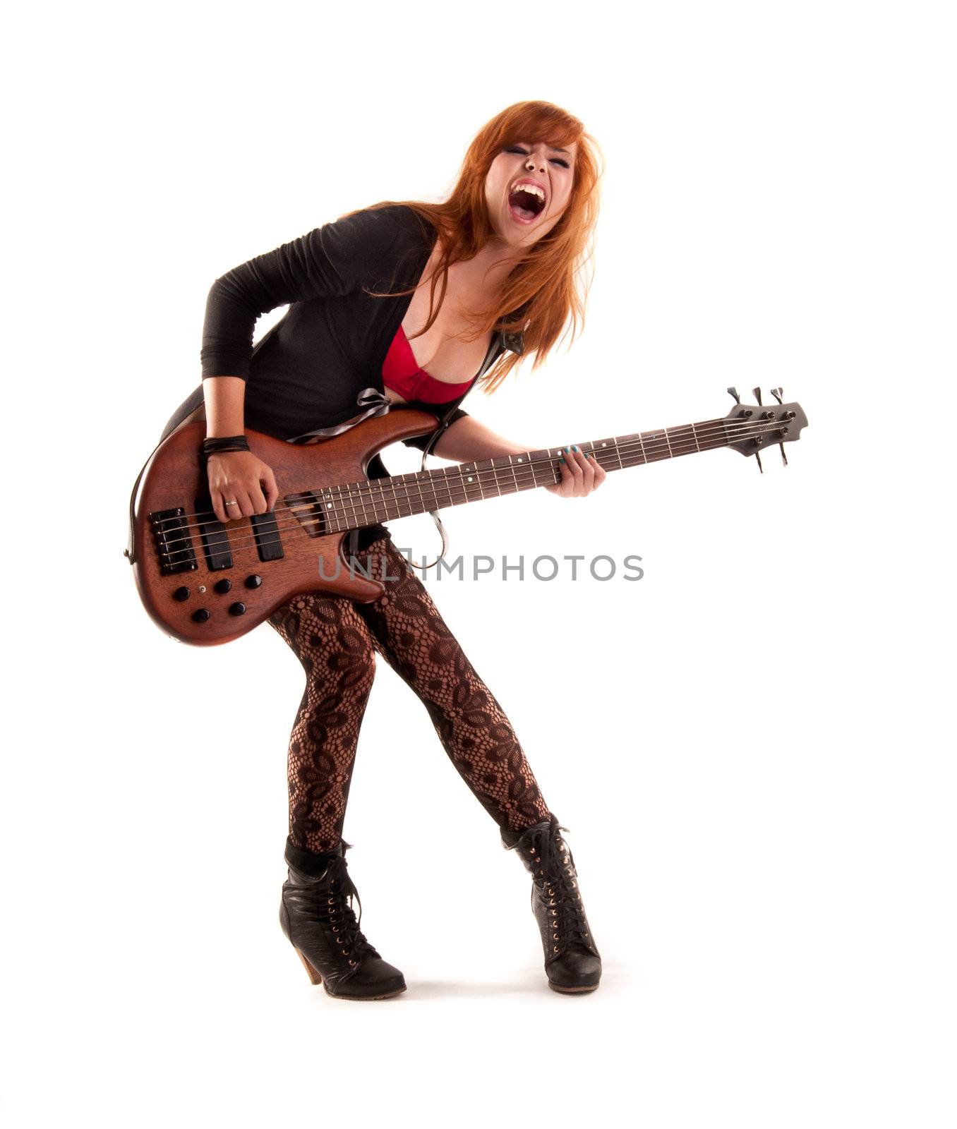 Beautiful and sexy young girl rockin on her bass guitar