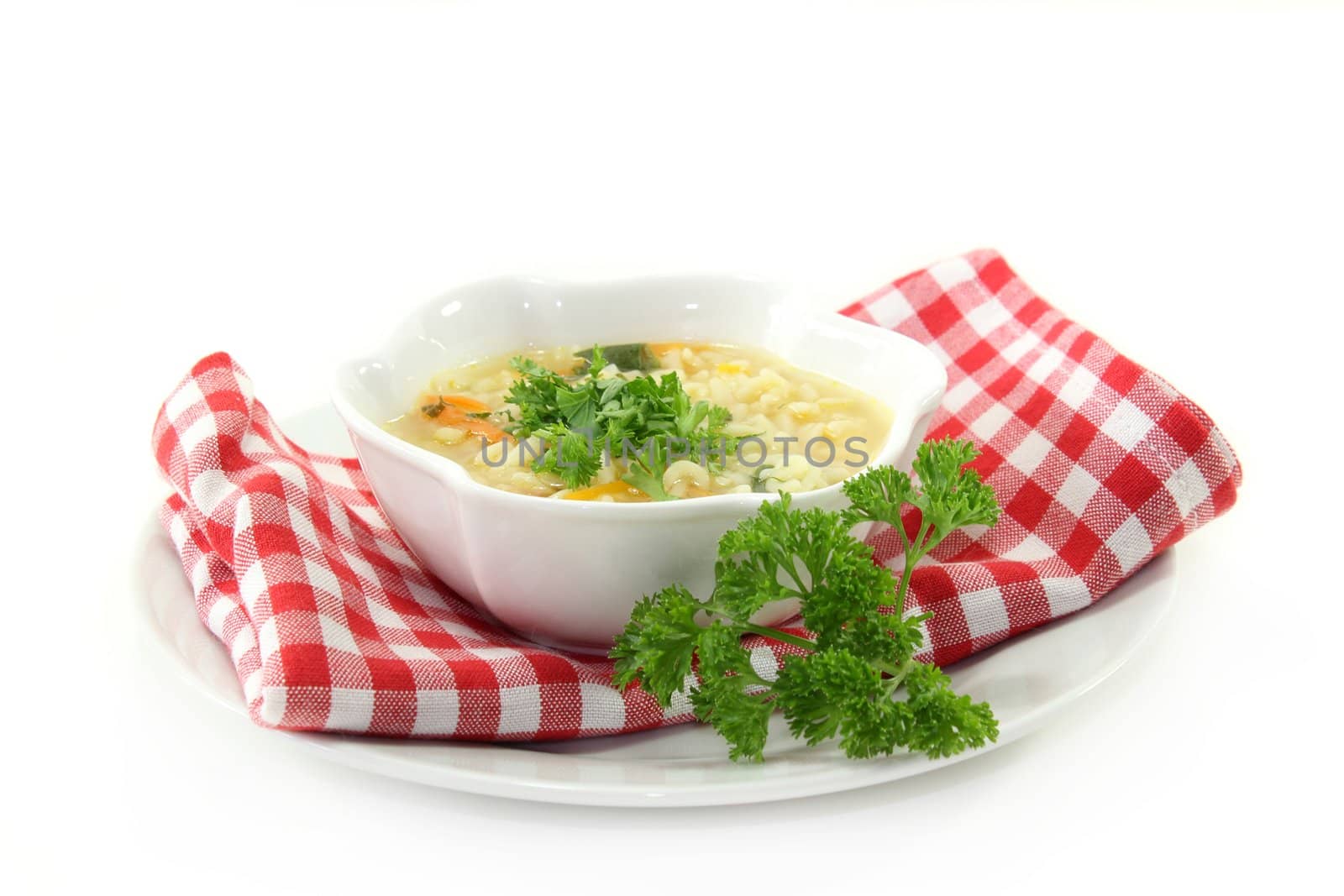 a bowl of noodle soup with parsley and fresh ingredients