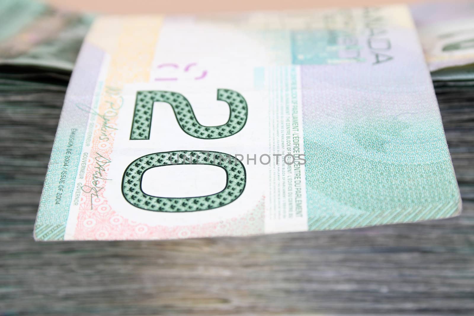 Pile of twenty dollar bills with loose twenty on top, Canadian currencty