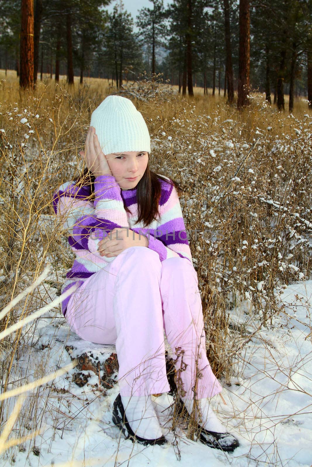 Young brunette teen in the field after the snowfall 