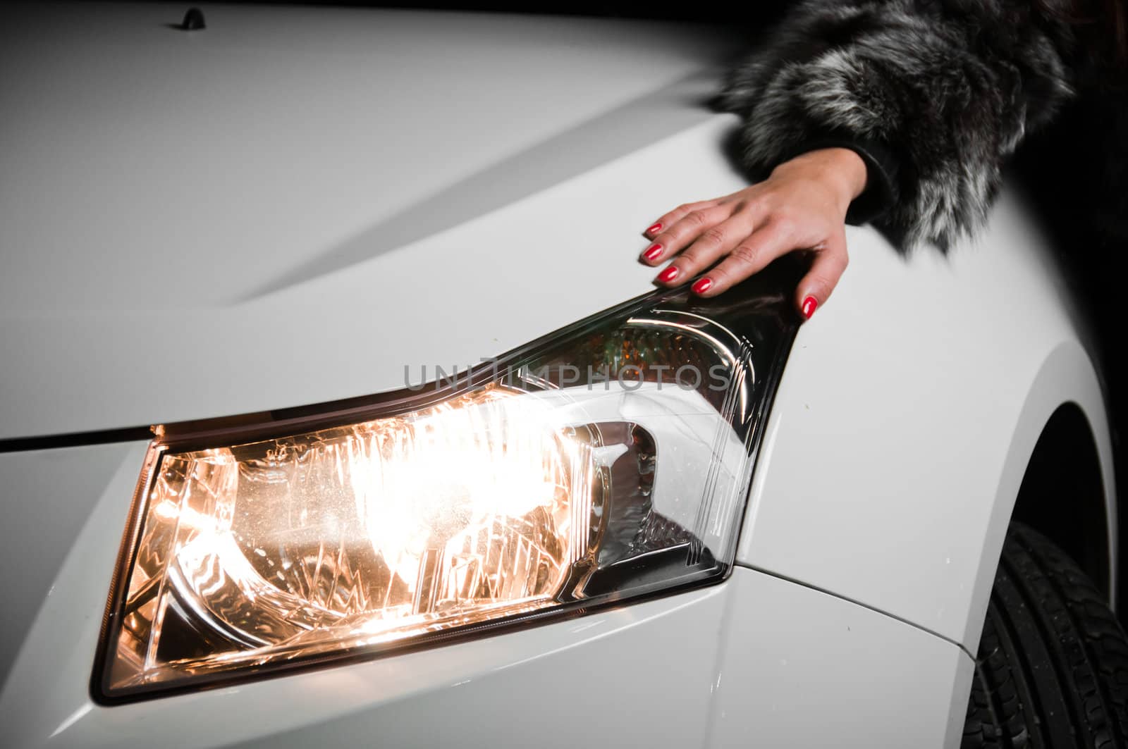 Girl little hand laying on white car hood