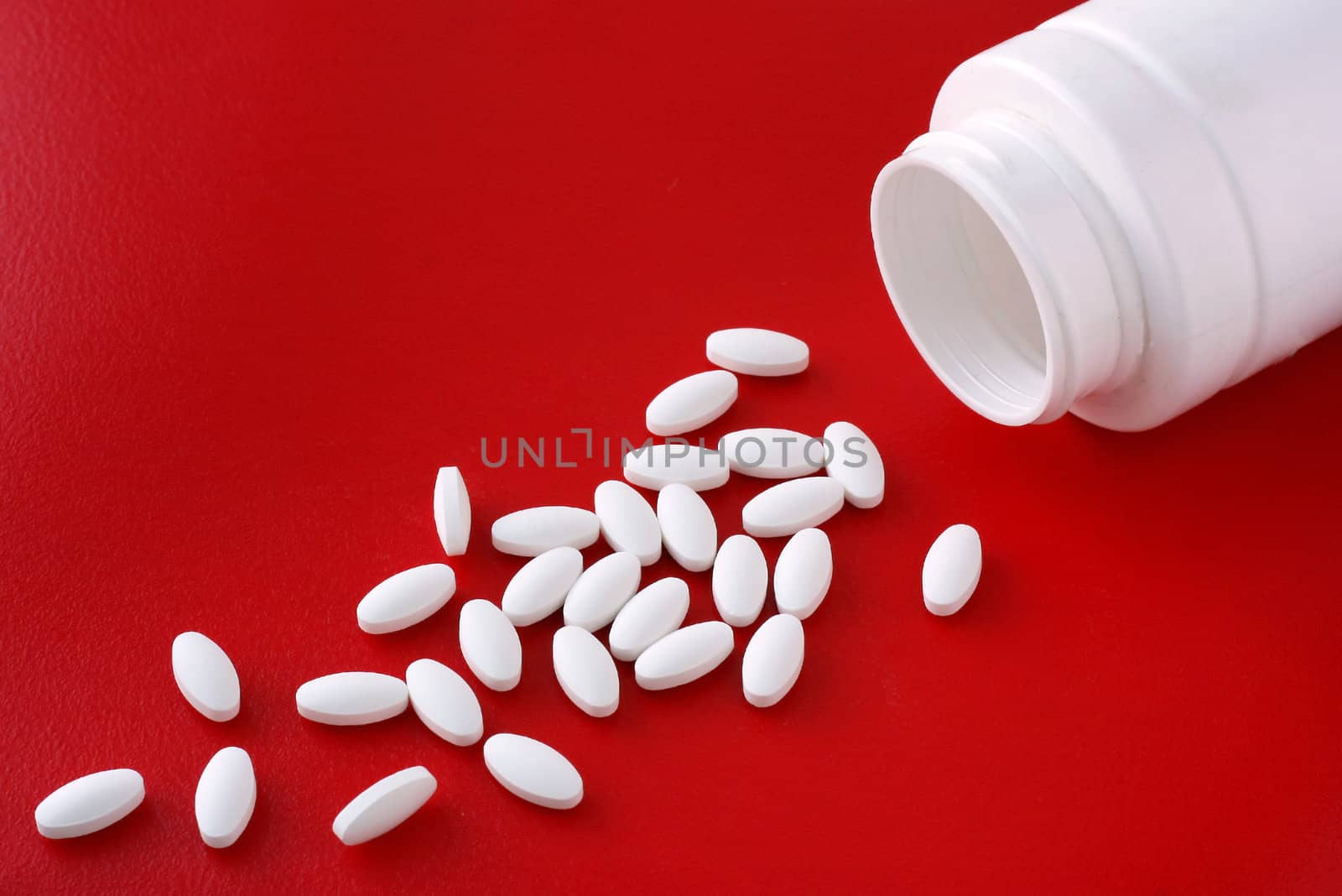 Spread and a bottle of pills lying on a red background