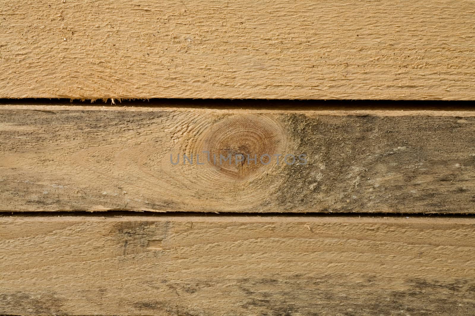 Stack of Building Lumber at Construction Site. Close up view of stacked wooden boards 