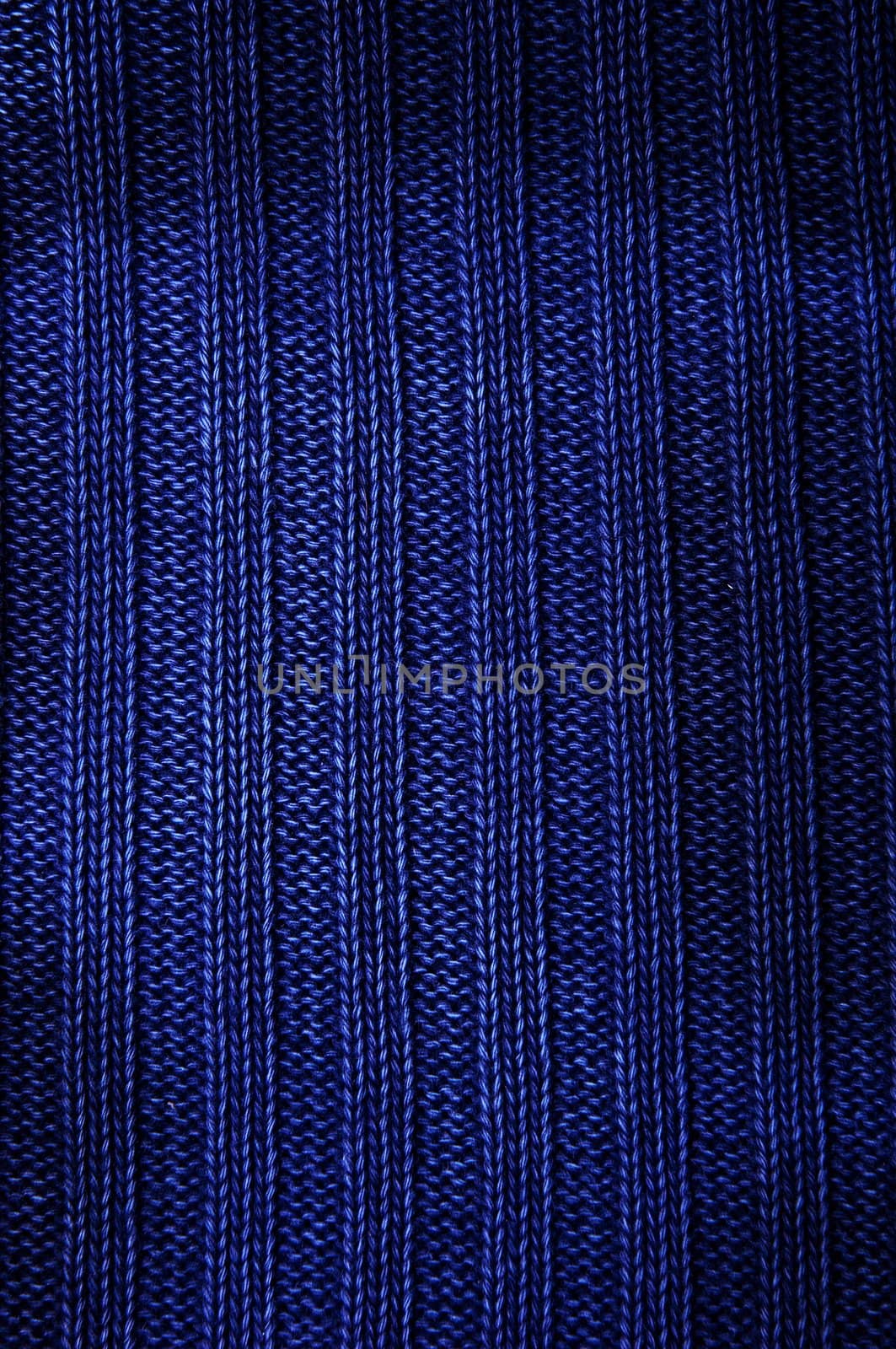 Background a texture a knitted fabric "elastic band" of dark blue color. Vertical