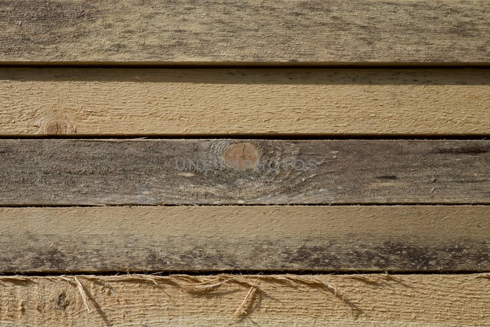 Stack of Building Lumber at Construction Site. Close up view of stacked wooden boards 
