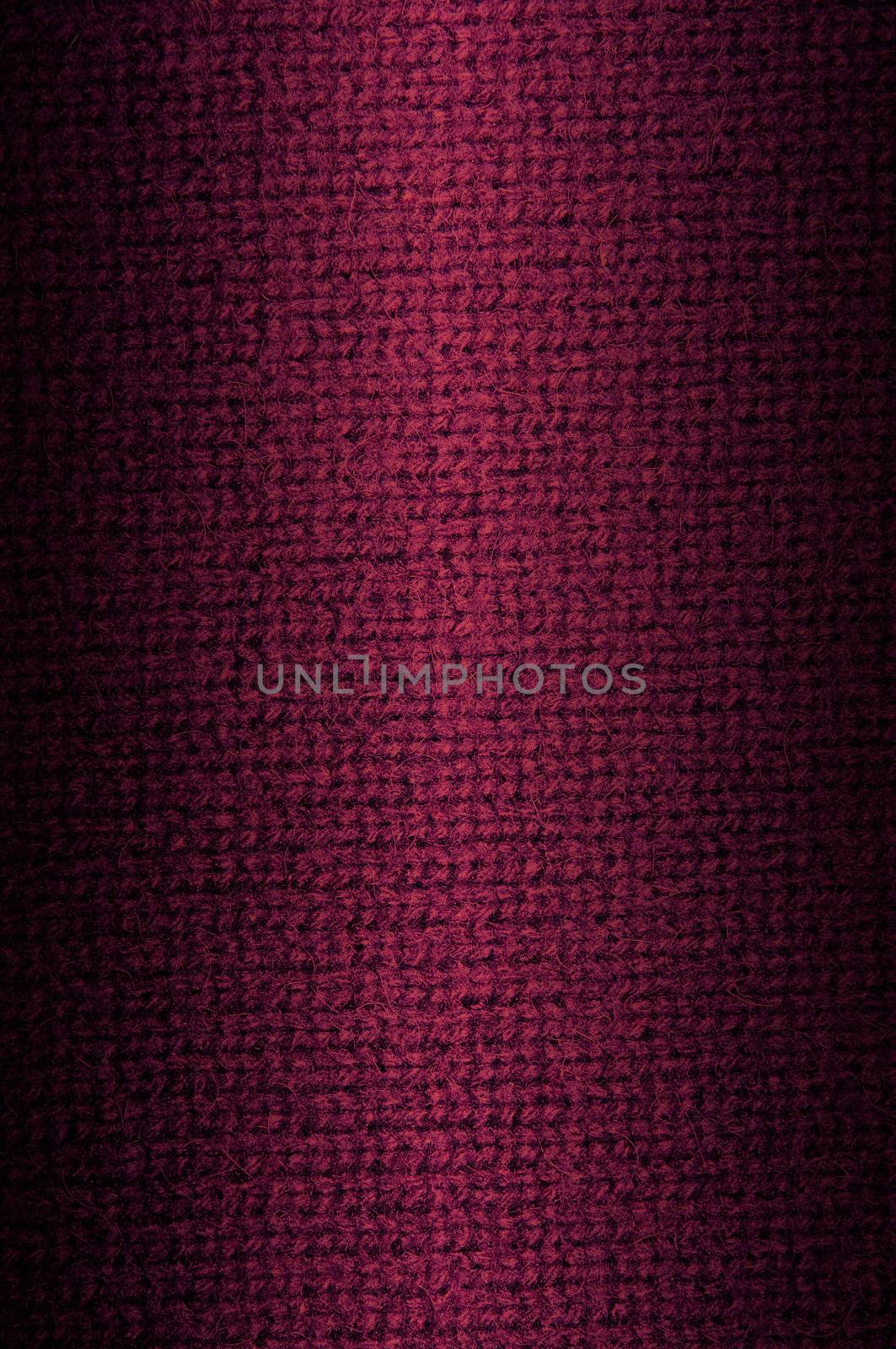 Background a texture a knitted woolen fabric of dark crimson color. Vertical