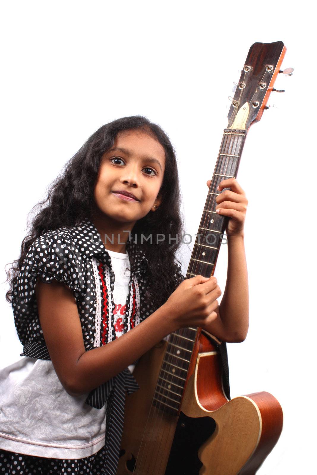 A young Indian girl with her guitar, on white studio background.
