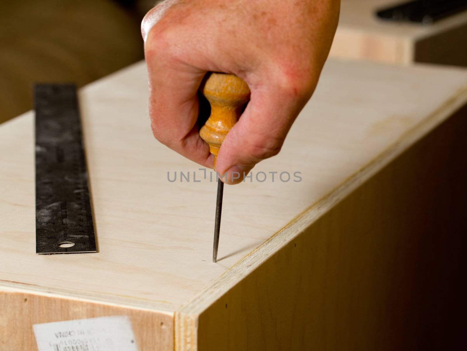 Making a hole in wood box with a bradall prior to screwing