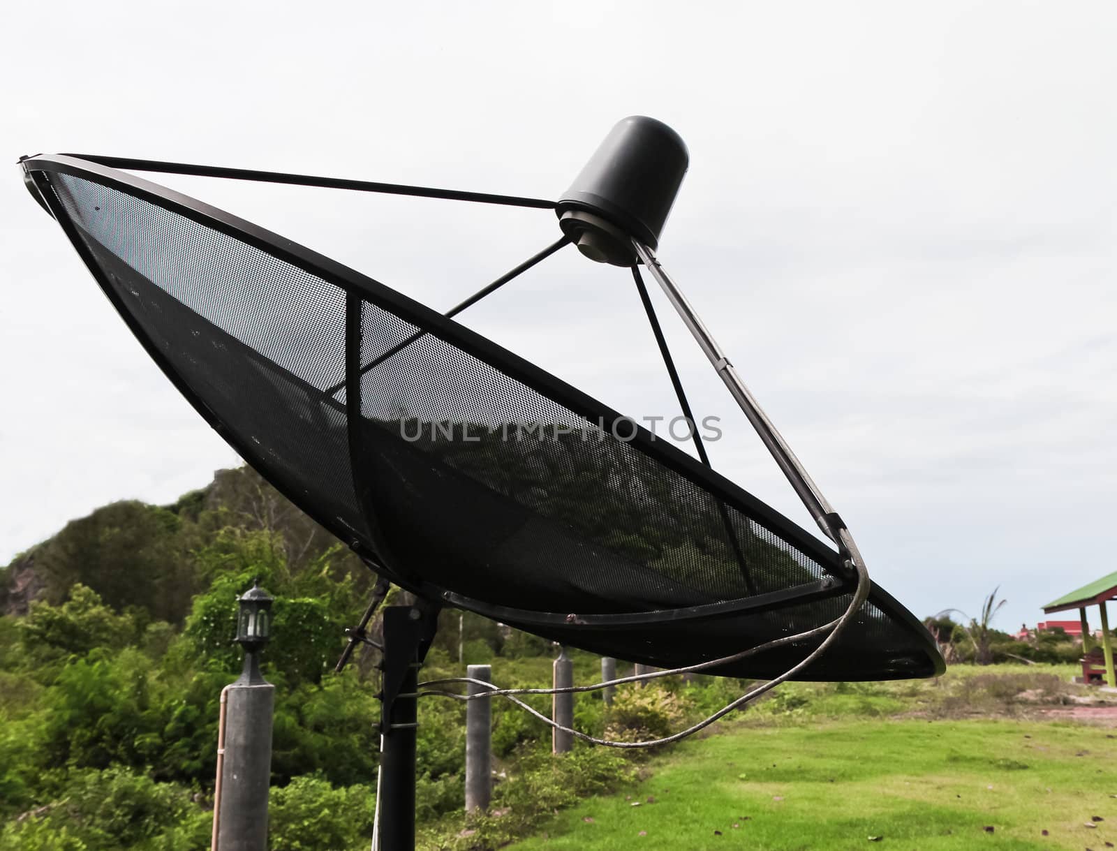 Satellite dish in morning sky.