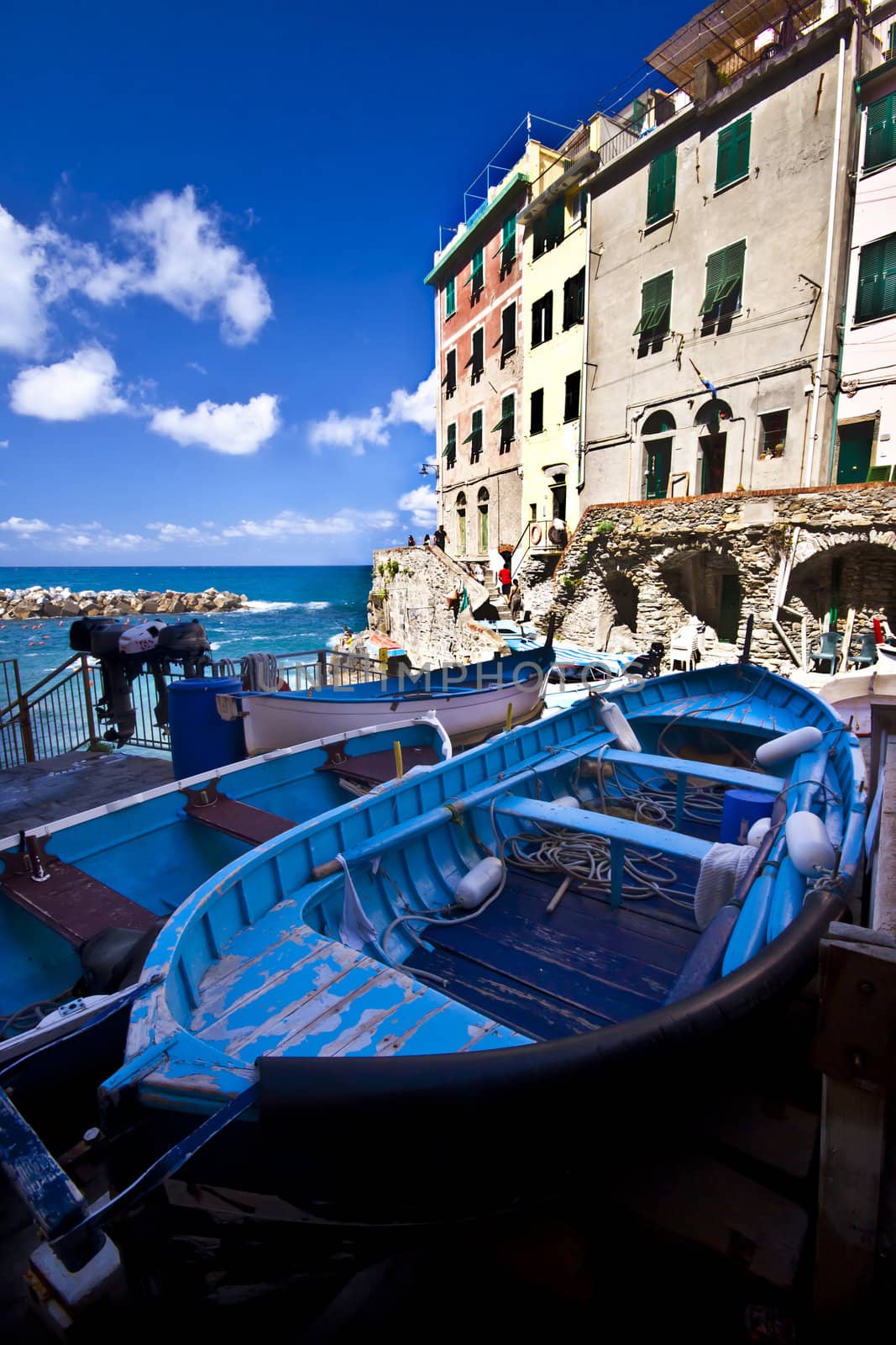 Fisherman village  Riomaggiore is one of five famous colorful villages of Cinque Terre in Italy, suspended between sea and land on sheer cliffs upon the  turquoise sea.