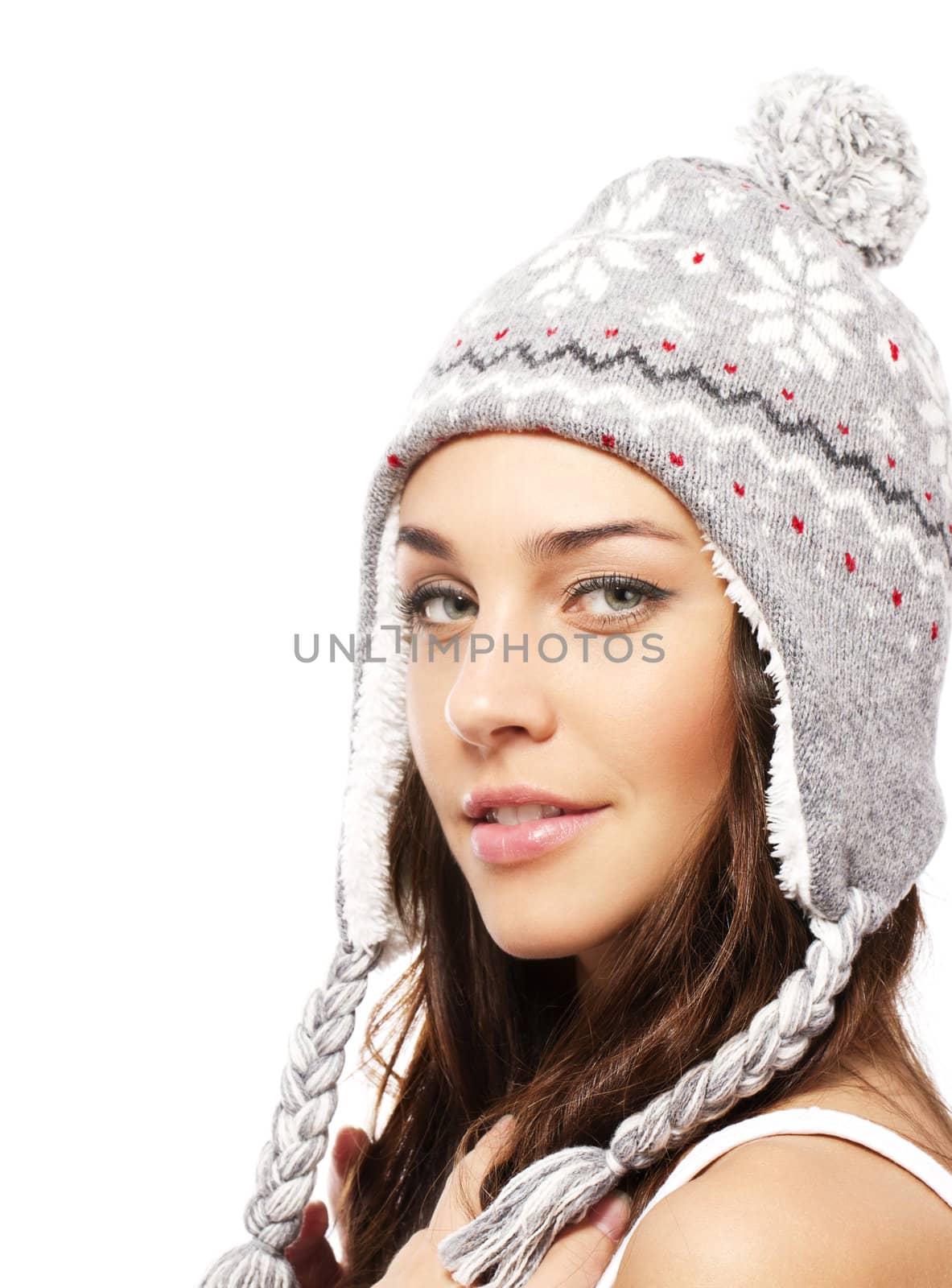 smiling young woman wearing winter cap on white background